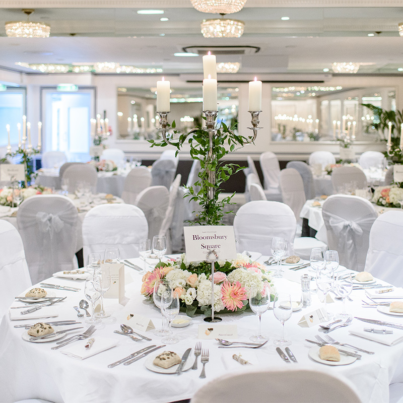 Elegant banquet hall with floral centerpieces, ideal for weddings and corporate events.
