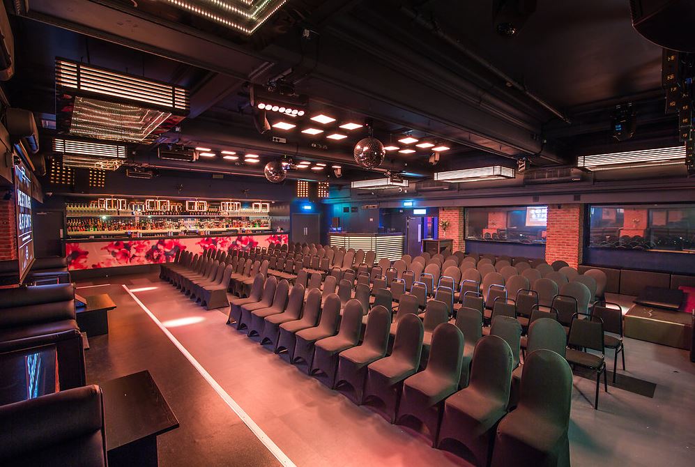 Modern event space in Sway with sleek black chairs, perfect for corporate and private events.