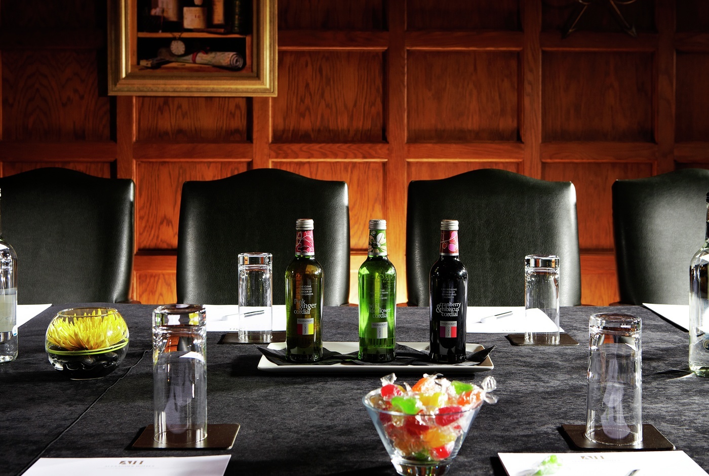 Meeting room at Langshott Manor Hotel with sleek table and vibrant candy centerpiece.