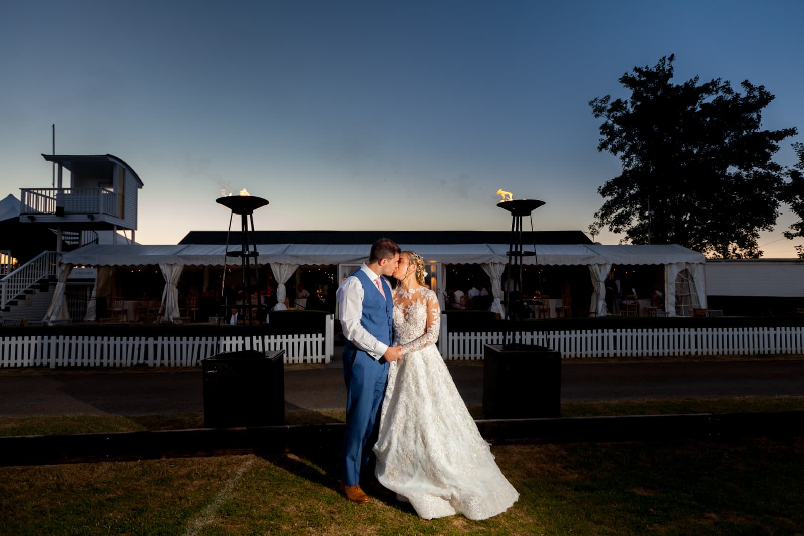 Outdoor wedding at Ham Polo Club with elegant marquee and romantic lighting.