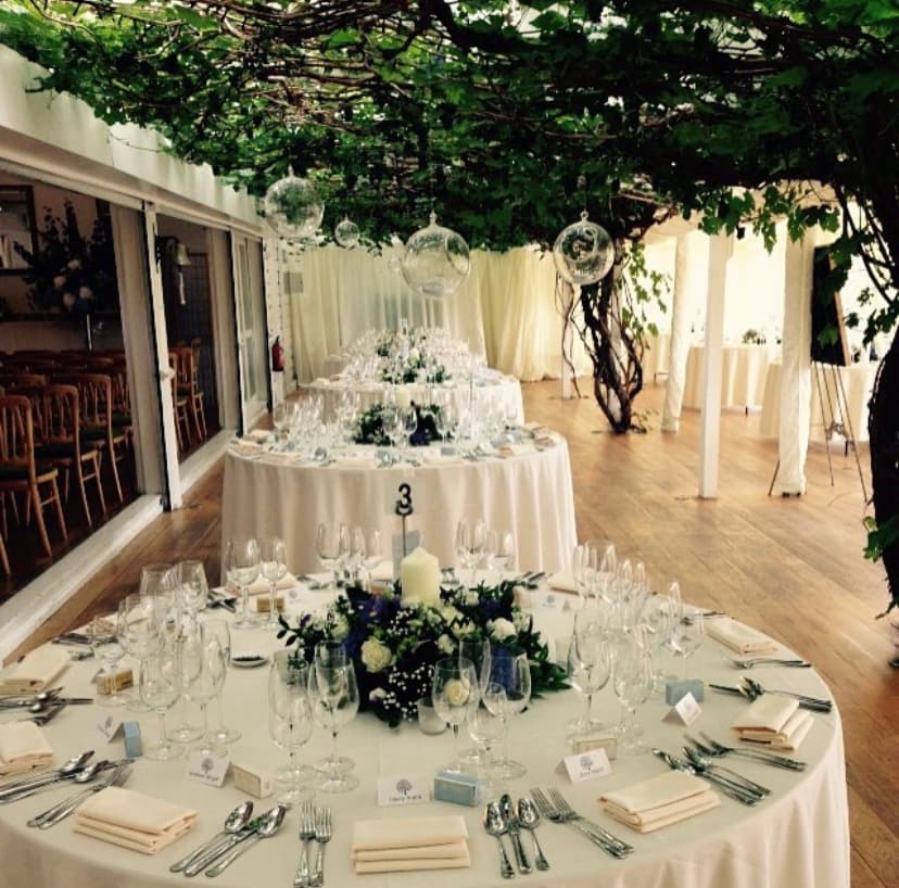 Elegant event space at Ham Polo Club with floral centerpieces for weddings.