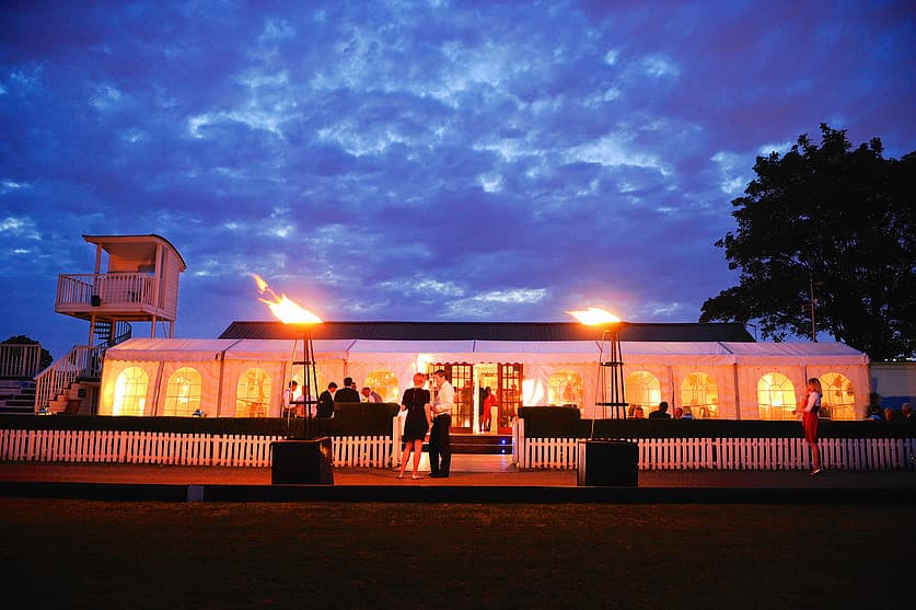 Outdoor event space at Ham Polo Club with illuminated tent and warm ambiance.