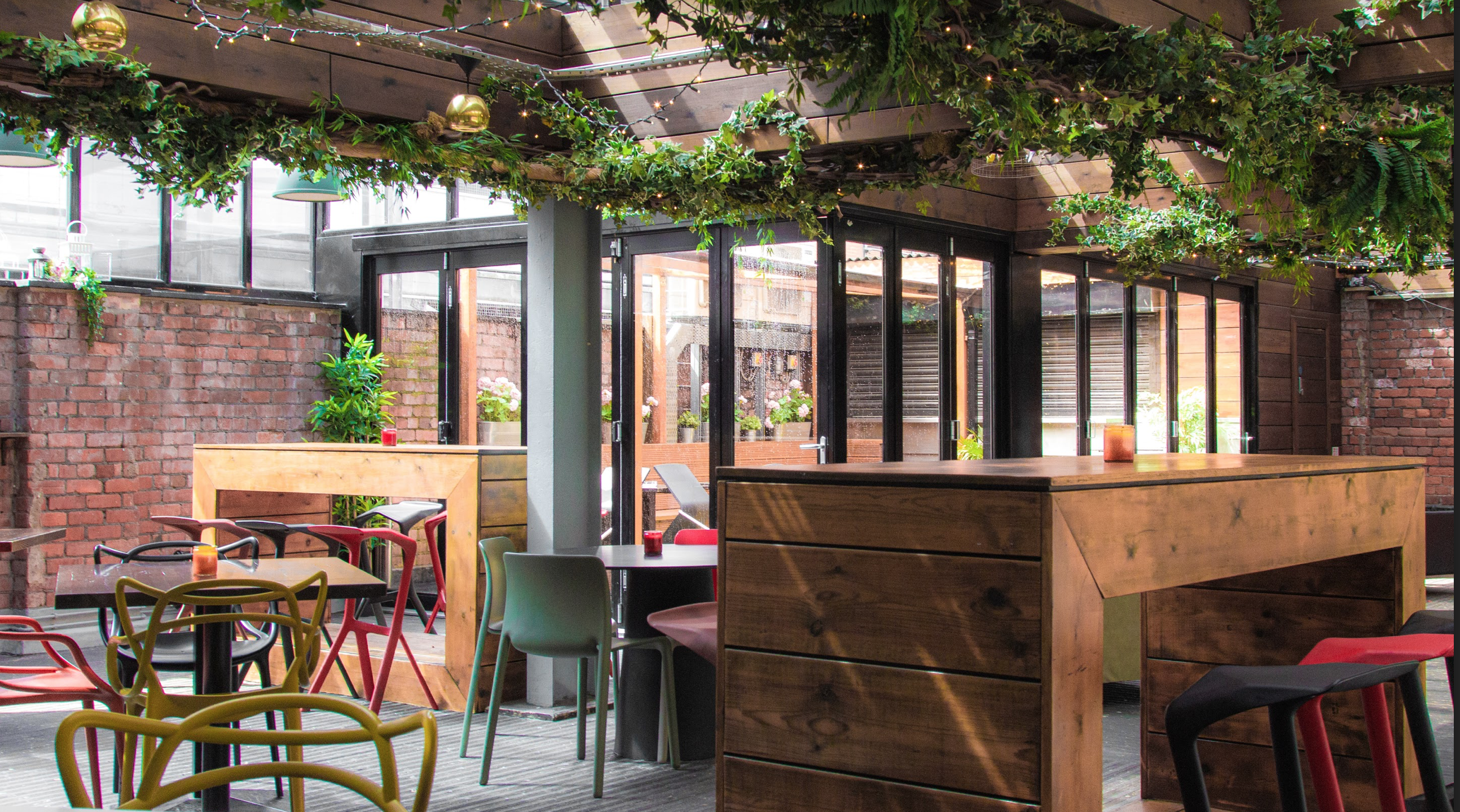 Stylish Greenhouse event space with greenery, perfect for networking and social gatherings.