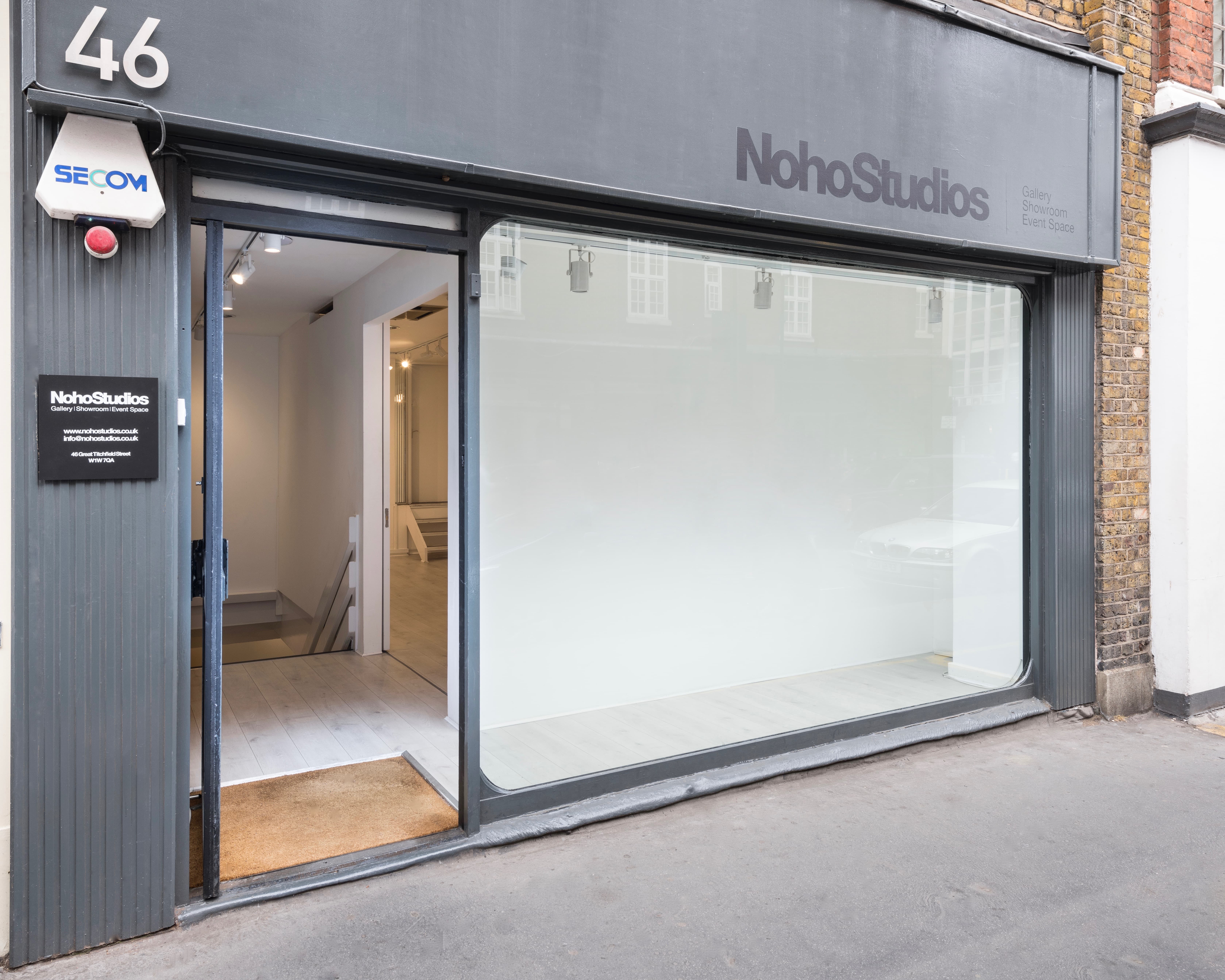 Modern minimalist venue exterior with large glass facade for events in Noho Studios.