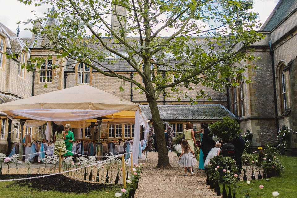 Elegant outdoor event space with tent and lush greenery at Le Gothique garden.