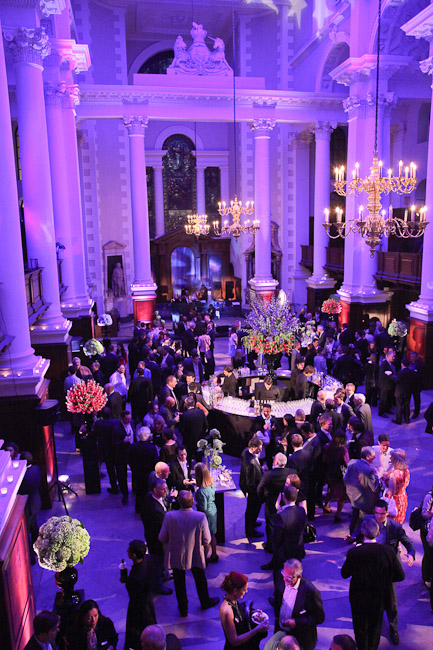 Vibrant networking event in Christ Church Spitalfields with elegant floral arrangements.