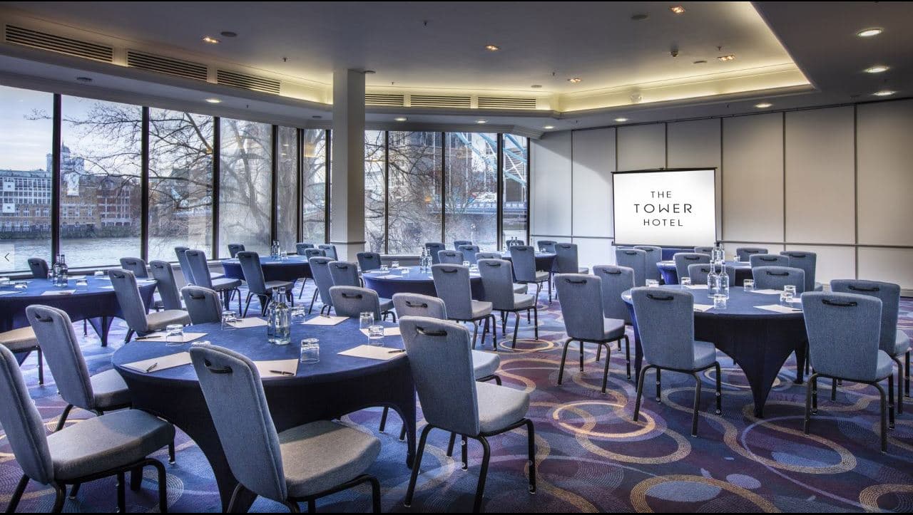 Tower Suite meeting room with round tables, ideal for conferences and professional events.