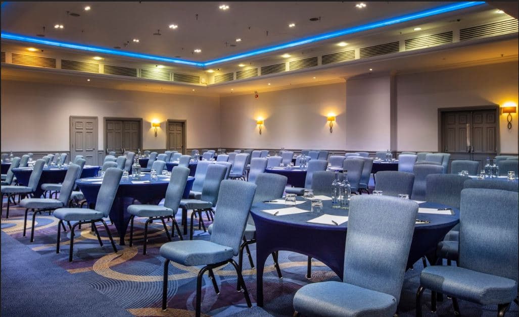 Tower Suite event space with round tables, ideal for meetings and conferences.