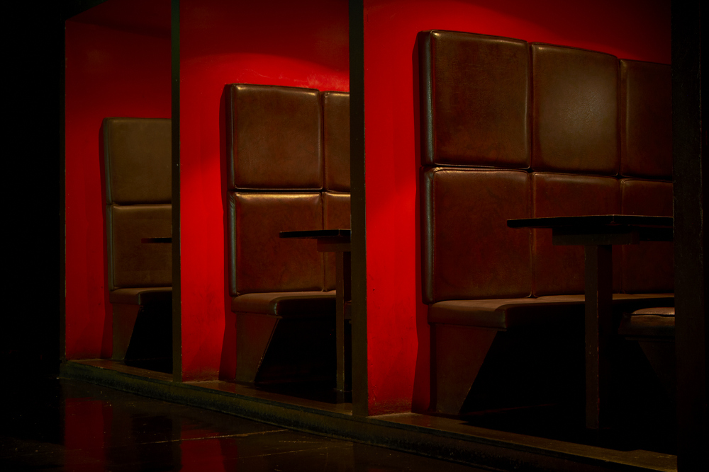 Modern booth with brown leather seating in Scala venue for networking events.