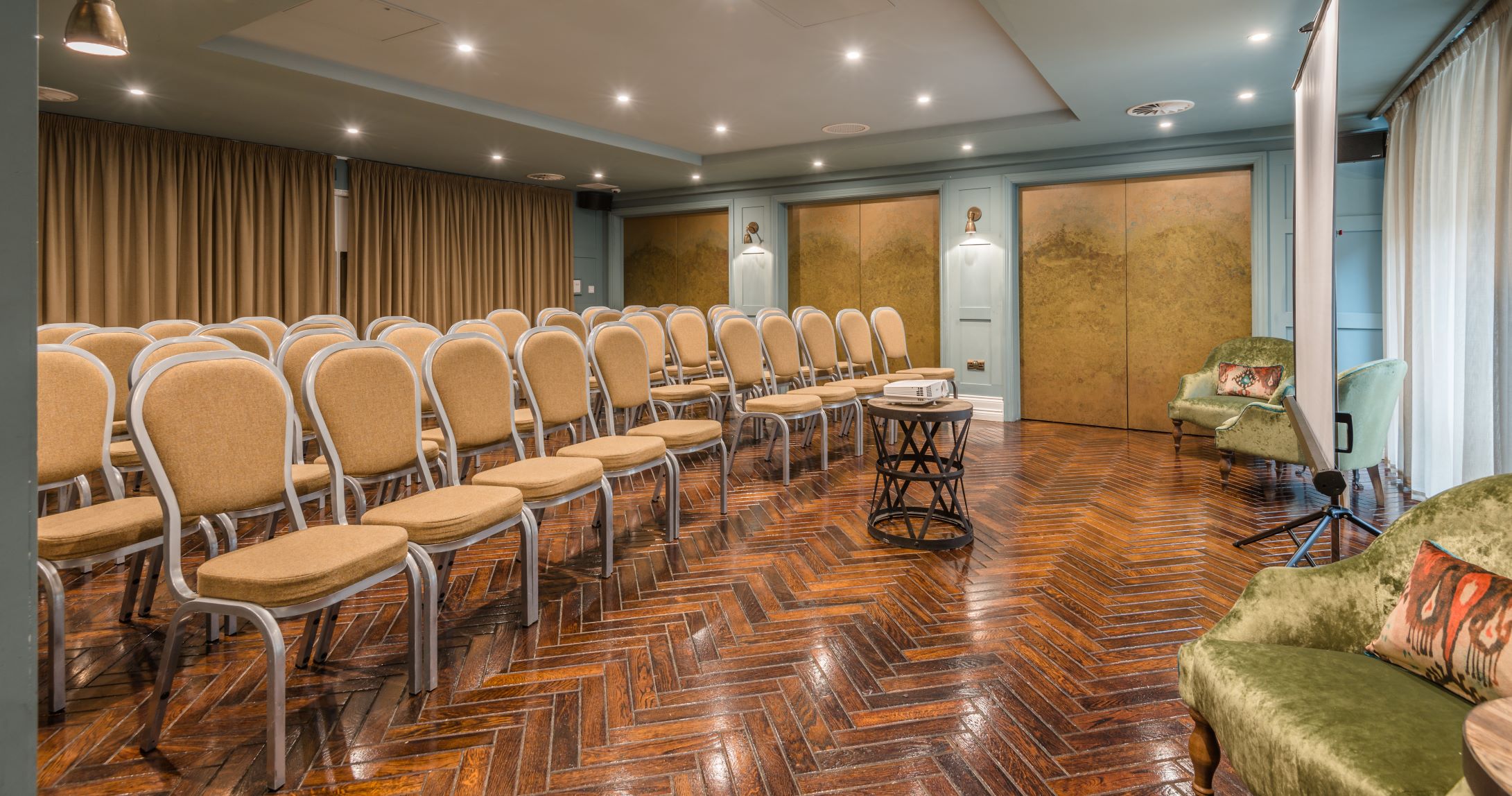 Meeting space at King Street Townhouse with beige chairs, ideal for workshops and seminars.