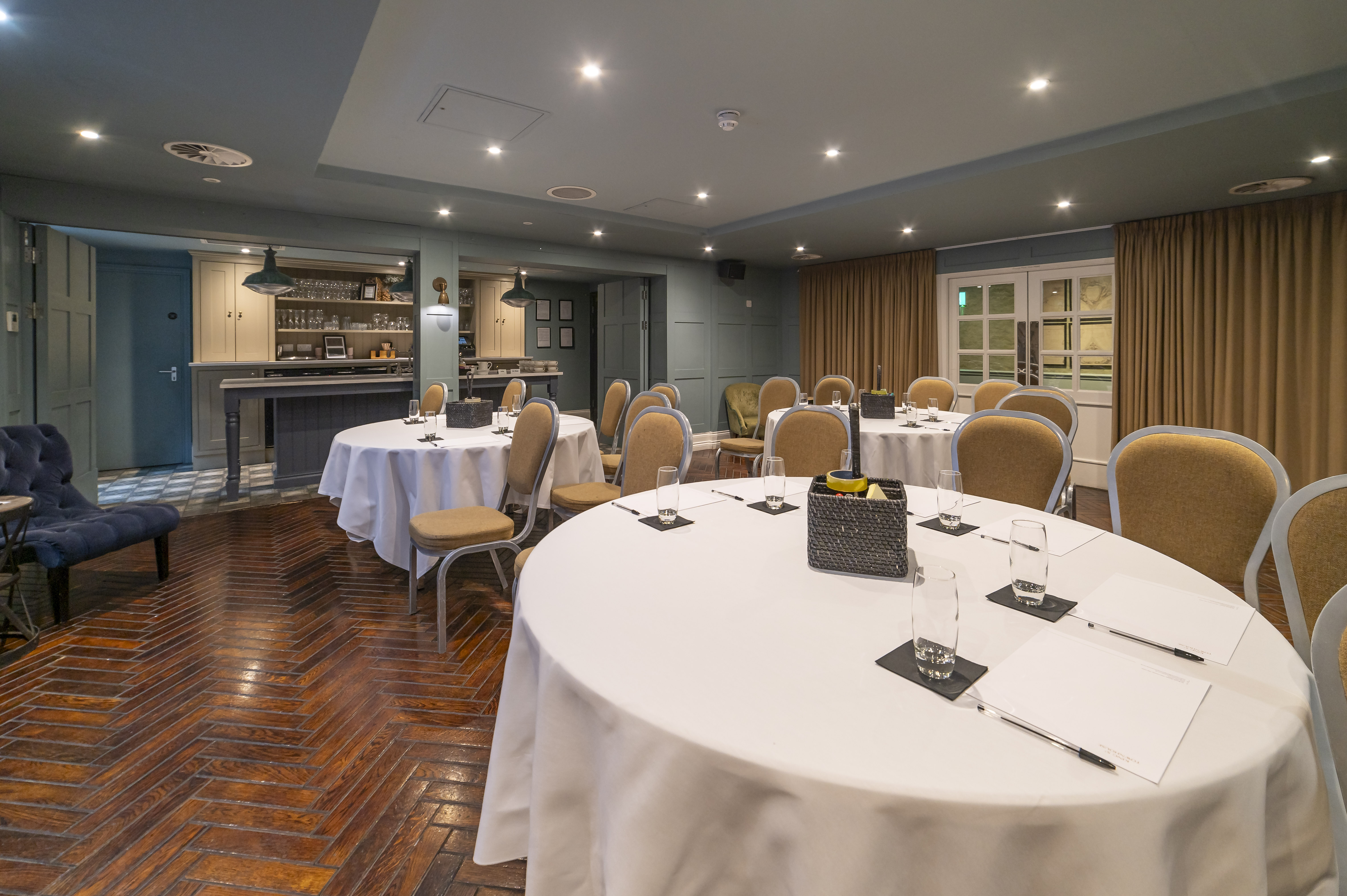 Elegant meeting room with round tables at King Street Townhouse for workshops and conferences.