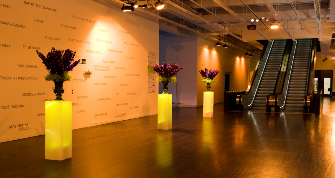 Tate Modern Level 3 Concourse with illuminated floral arrangements for events and receptions.