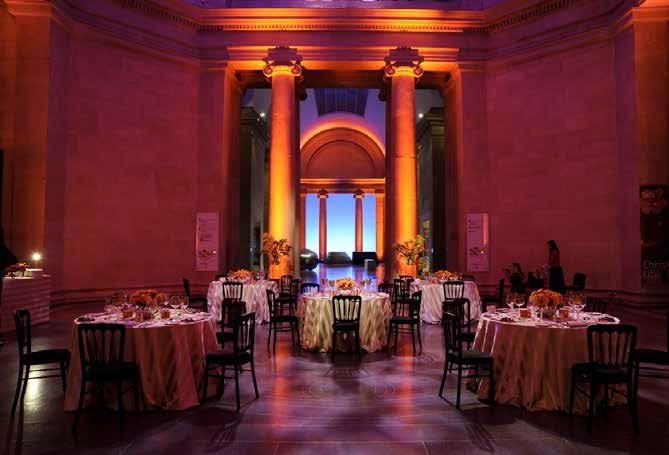 Sackler Octagon at Tate Britain, elegant event space with floral centerpieces and warm lighting.