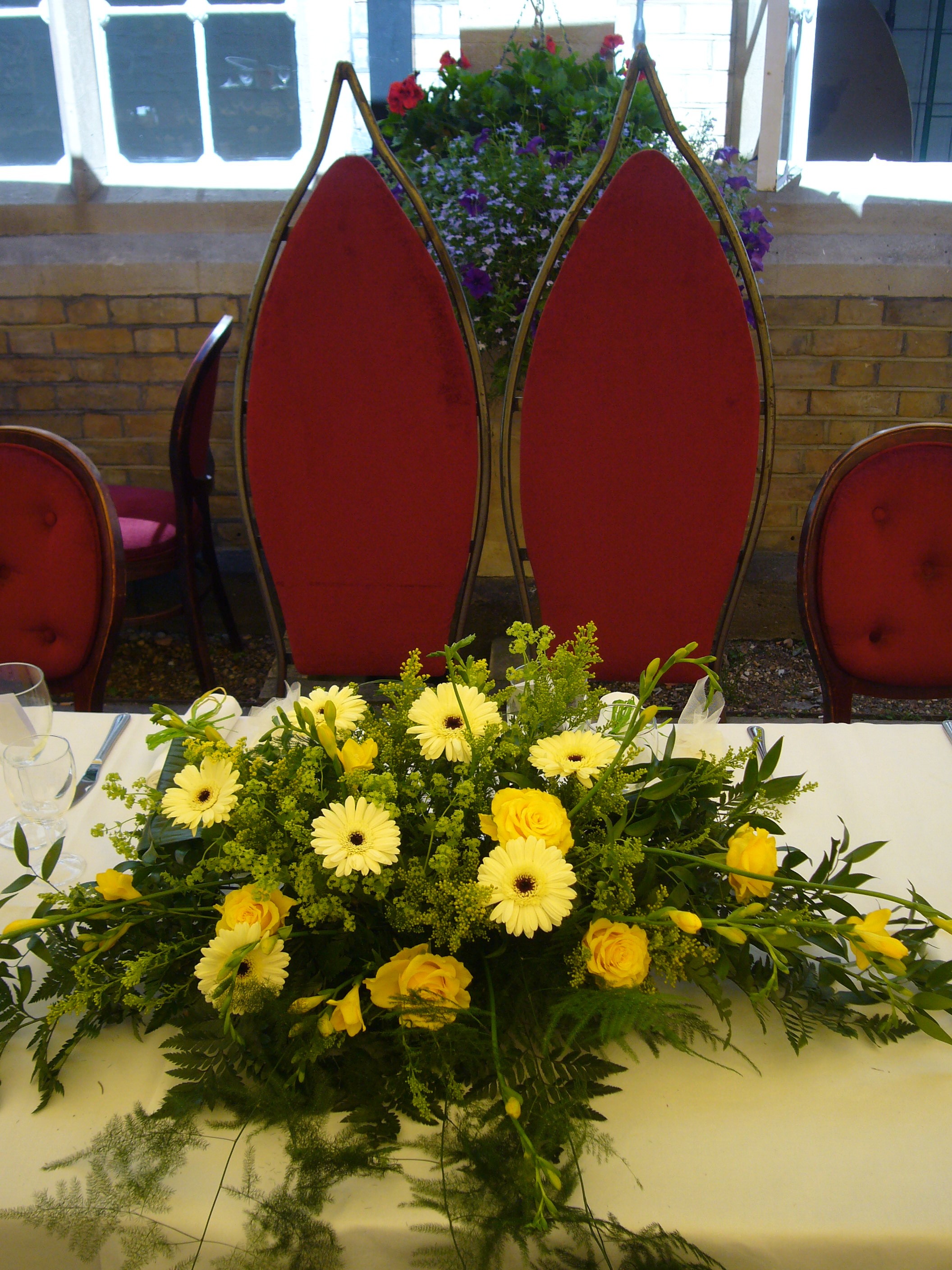 Elegant table with floral centerpiece in Le Gothique garden for weddings and events.