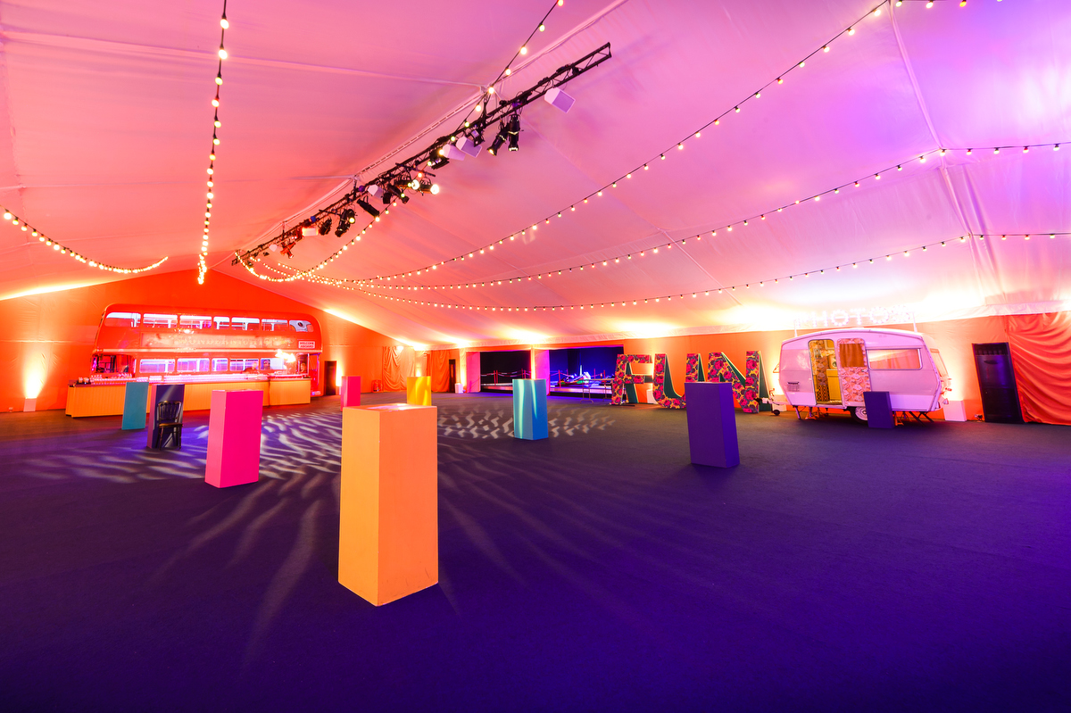 Vibrant event space at HAC with tent, colorful displays, ideal for product launches and gatherings.