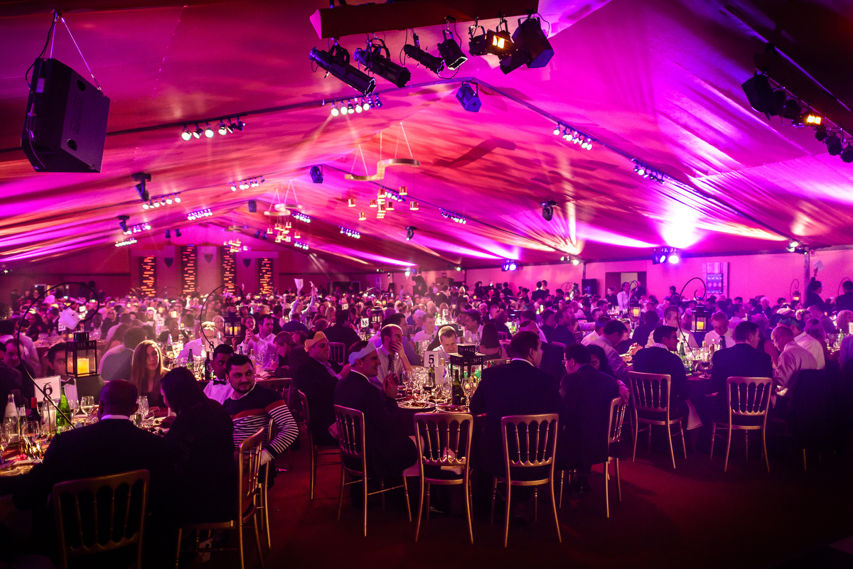 Elegant gala in The Artillery Garden, featuring vibrant lighting and round tables.
