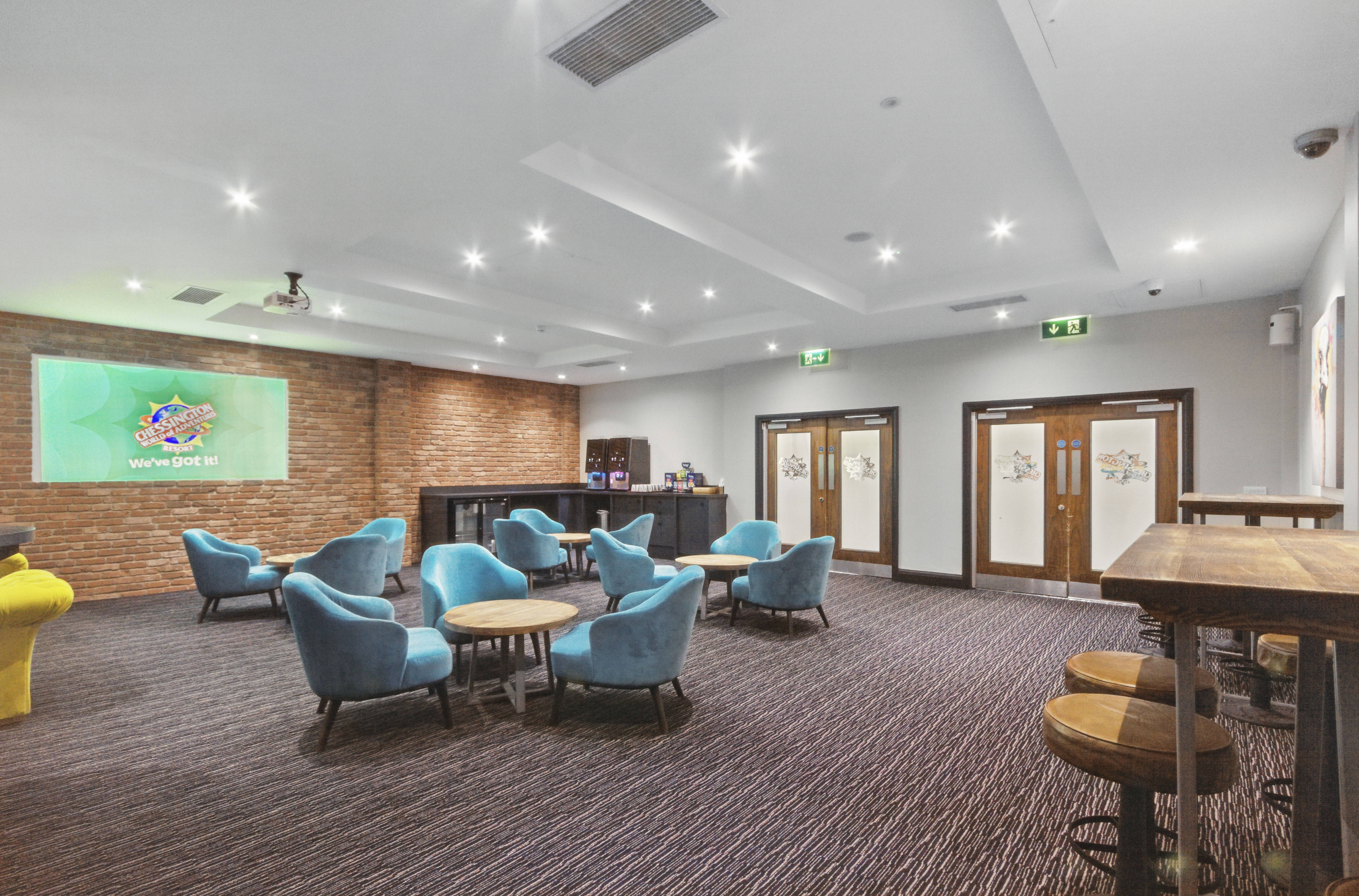 Modern event space with blue chairs, ideal for networking and meetings at Chessington Resort.