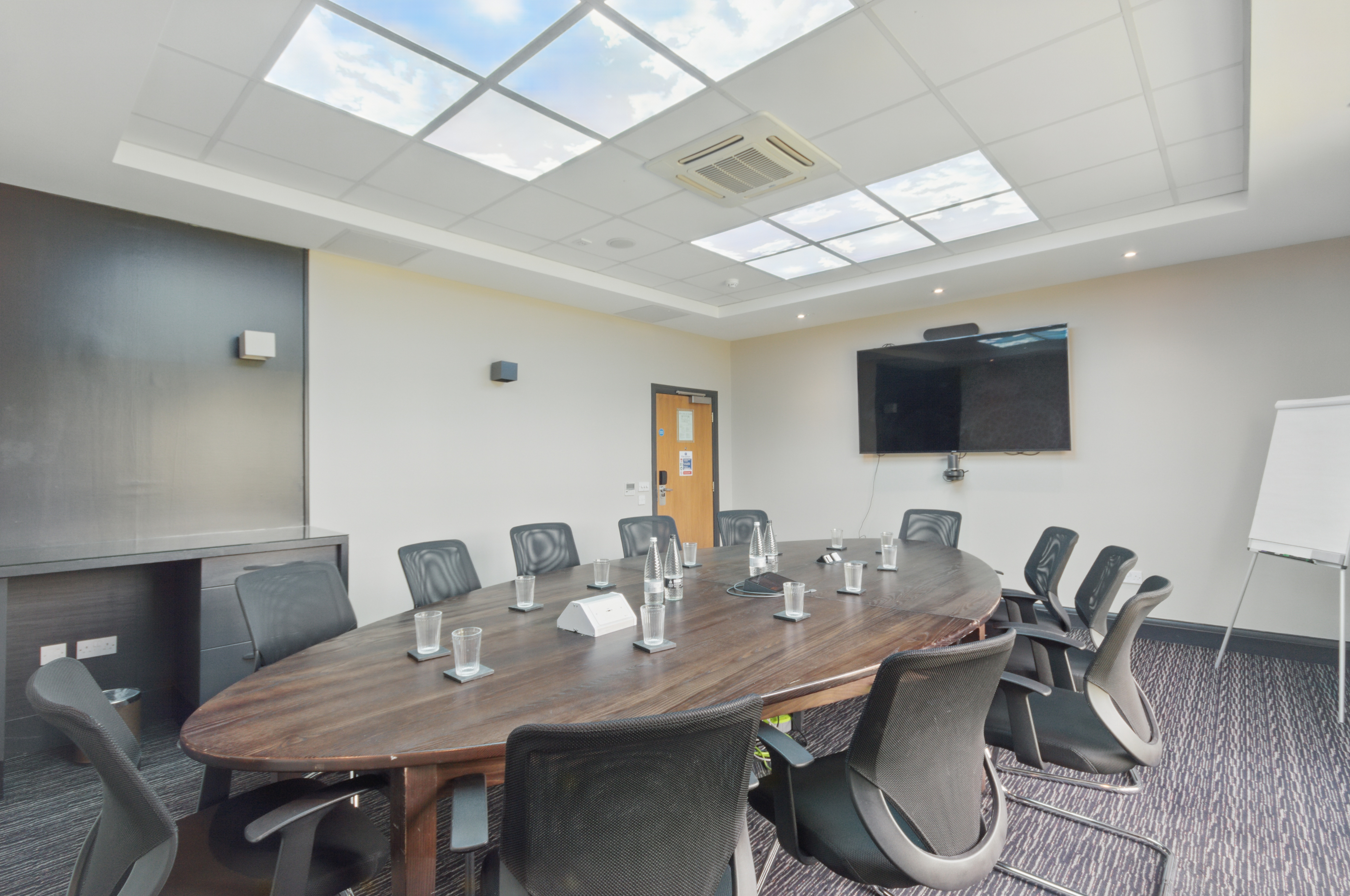 Modern meeting room with oval table, ideal for workshops and presentations at Chessington Resort.