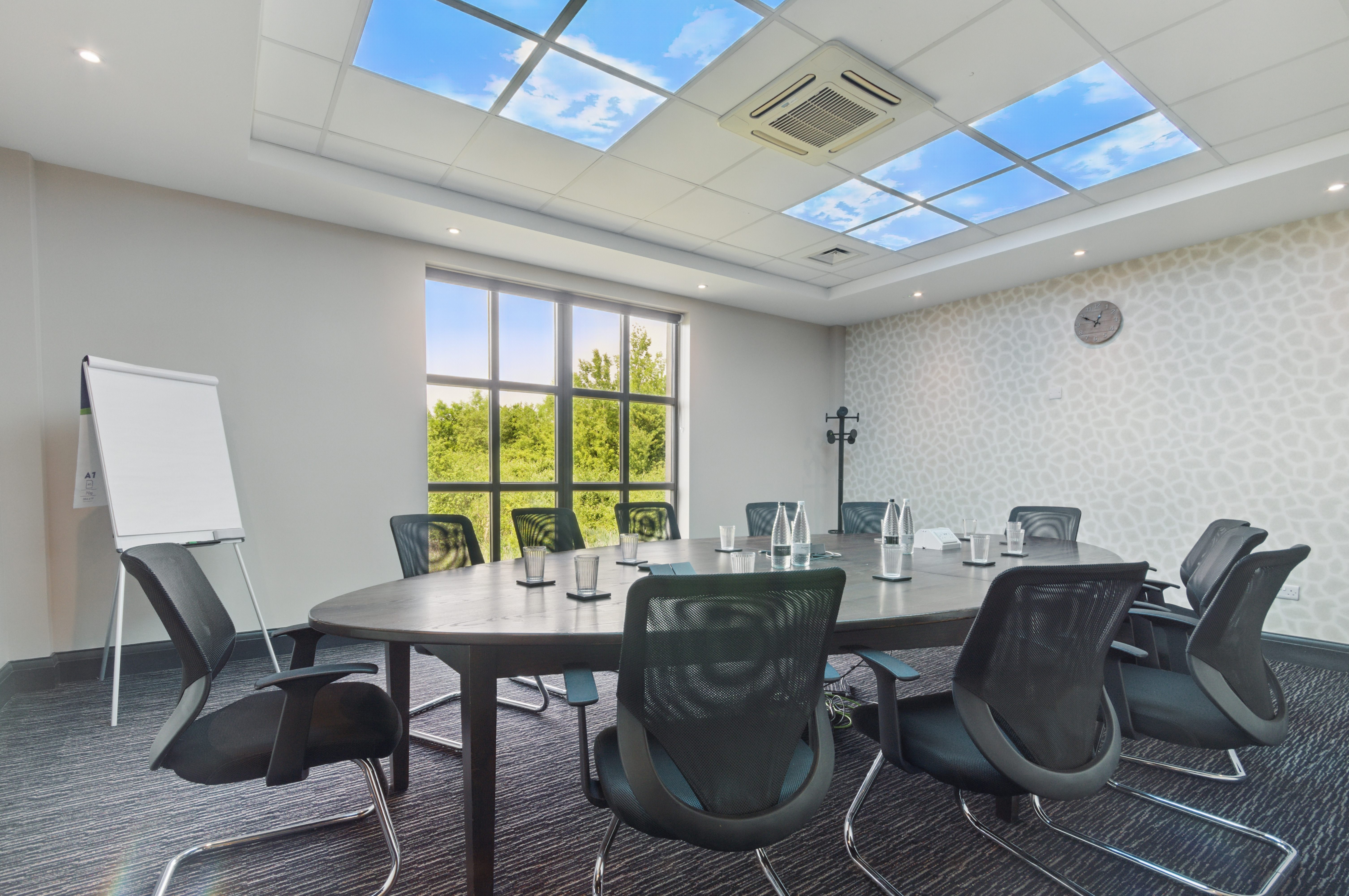 Modern meeting room with oval table, ideal for corporate events and brainstorming sessions.