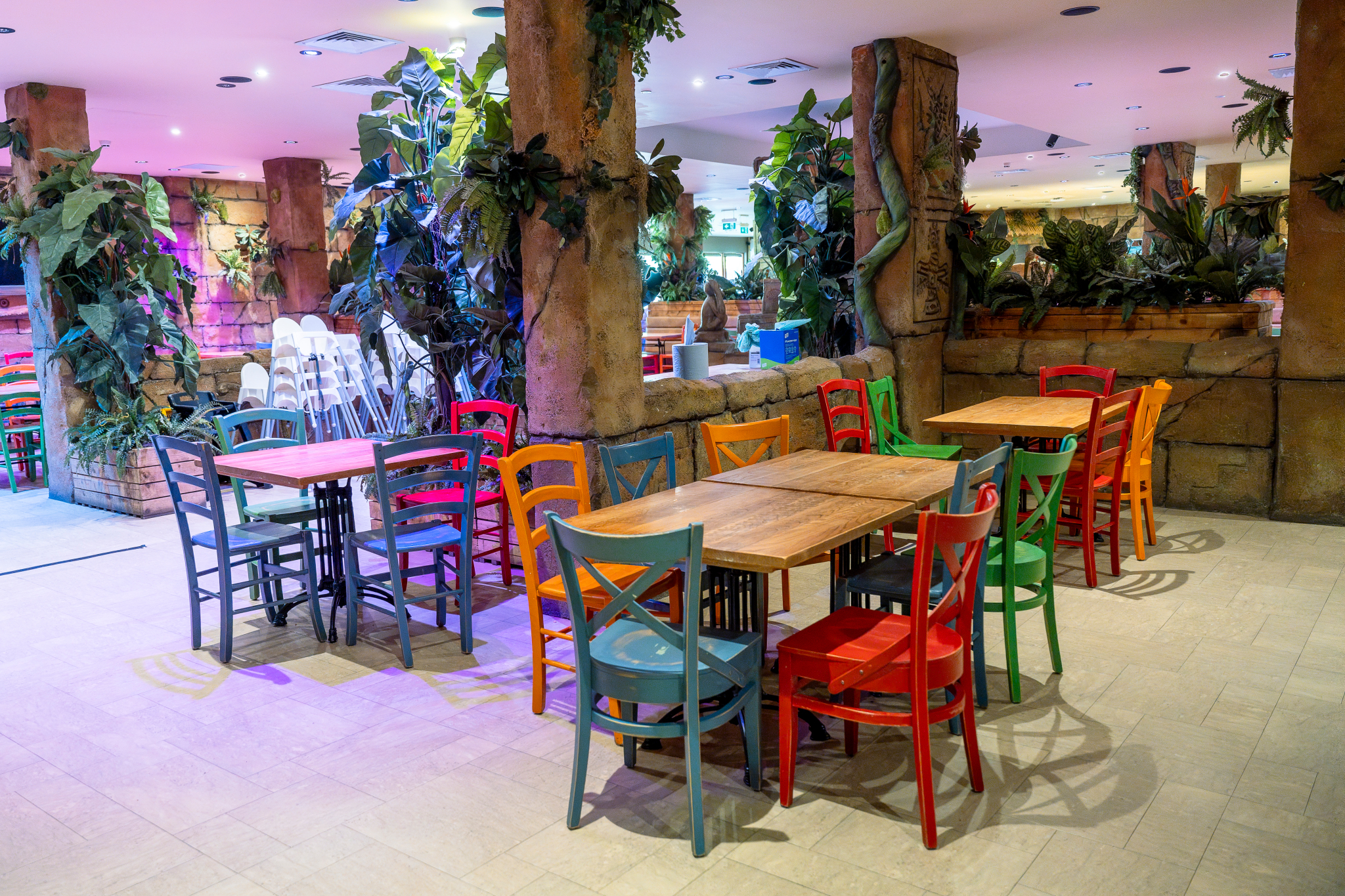 Vibrant Temple Restaurant & Bar event space with colorful chairs, ideal for gatherings.