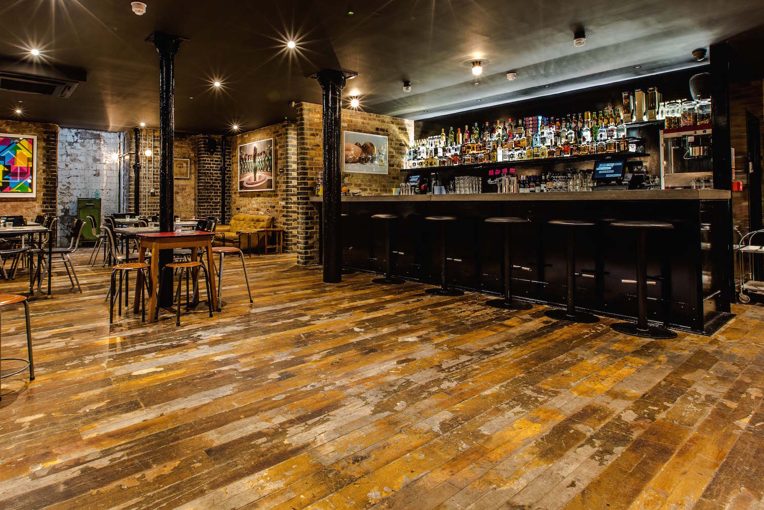 Basement Bar with exposed brick, ideal for networking events and casual gatherings.