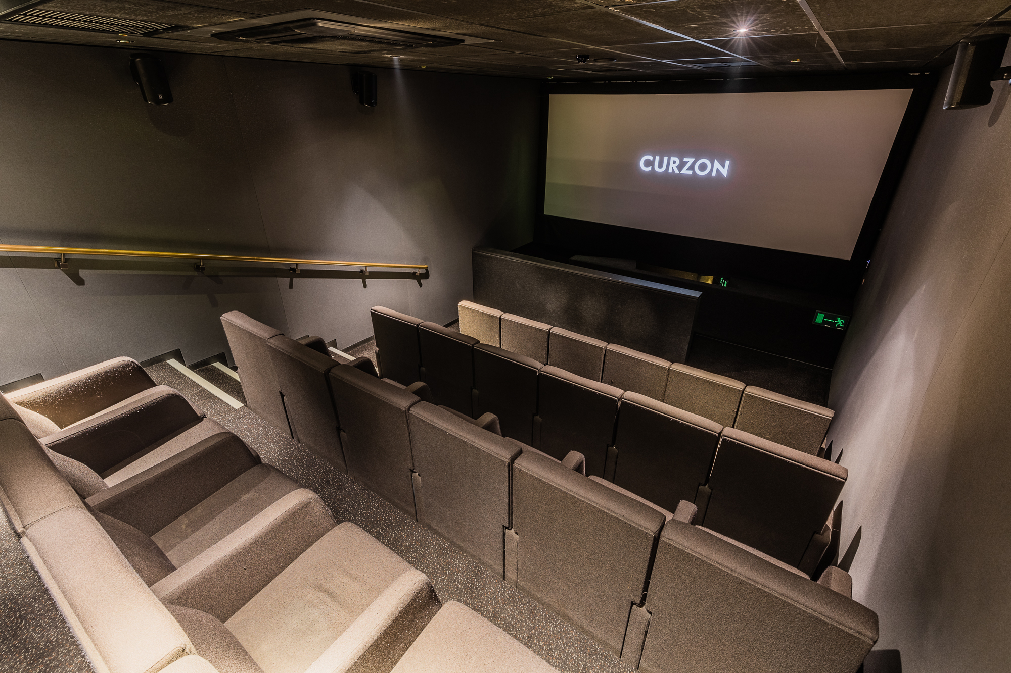 Modern screening room with tiered seating for film screenings and corporate events.