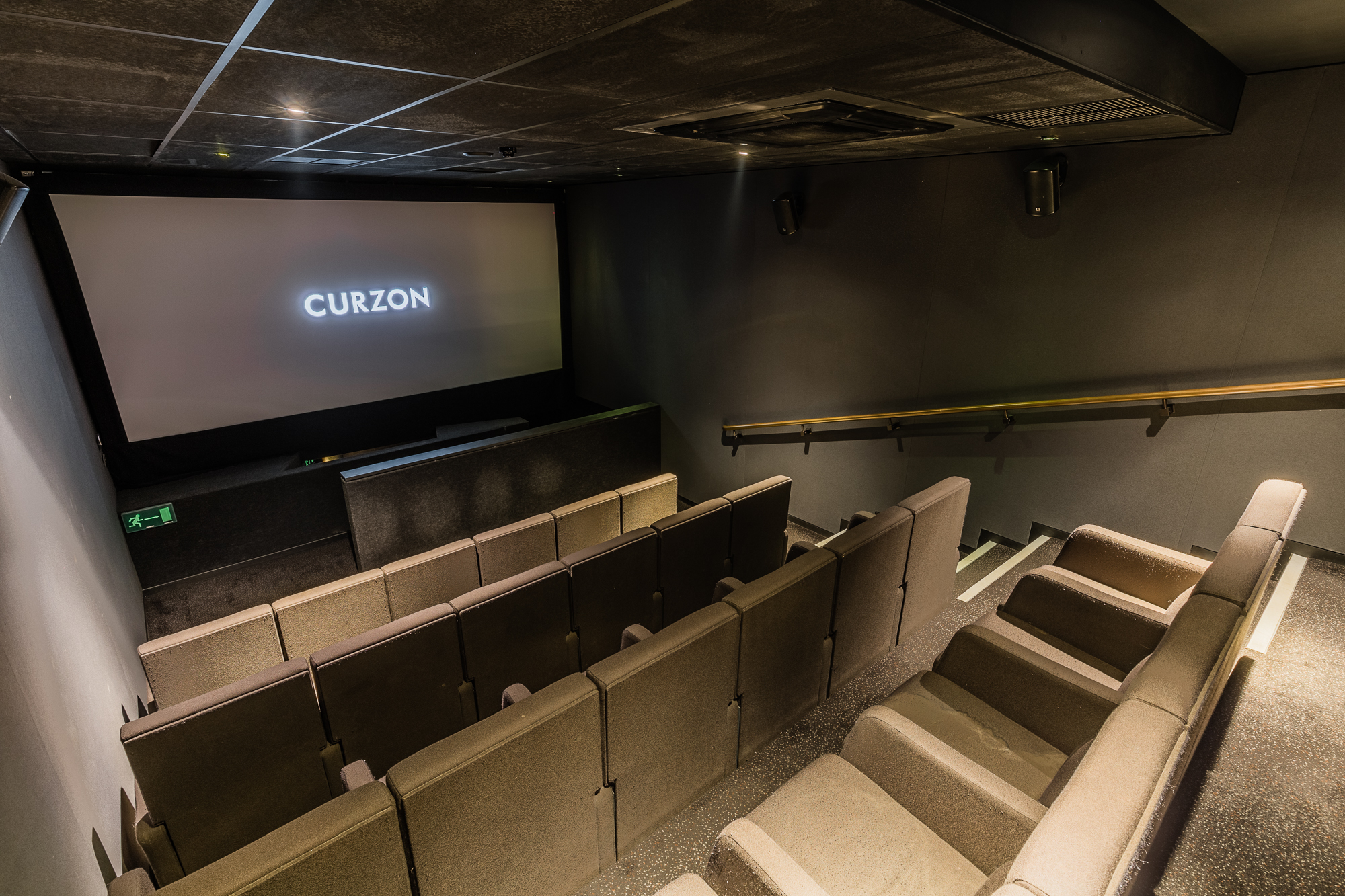 Modern screening room with tiered seating for film screenings and private events.