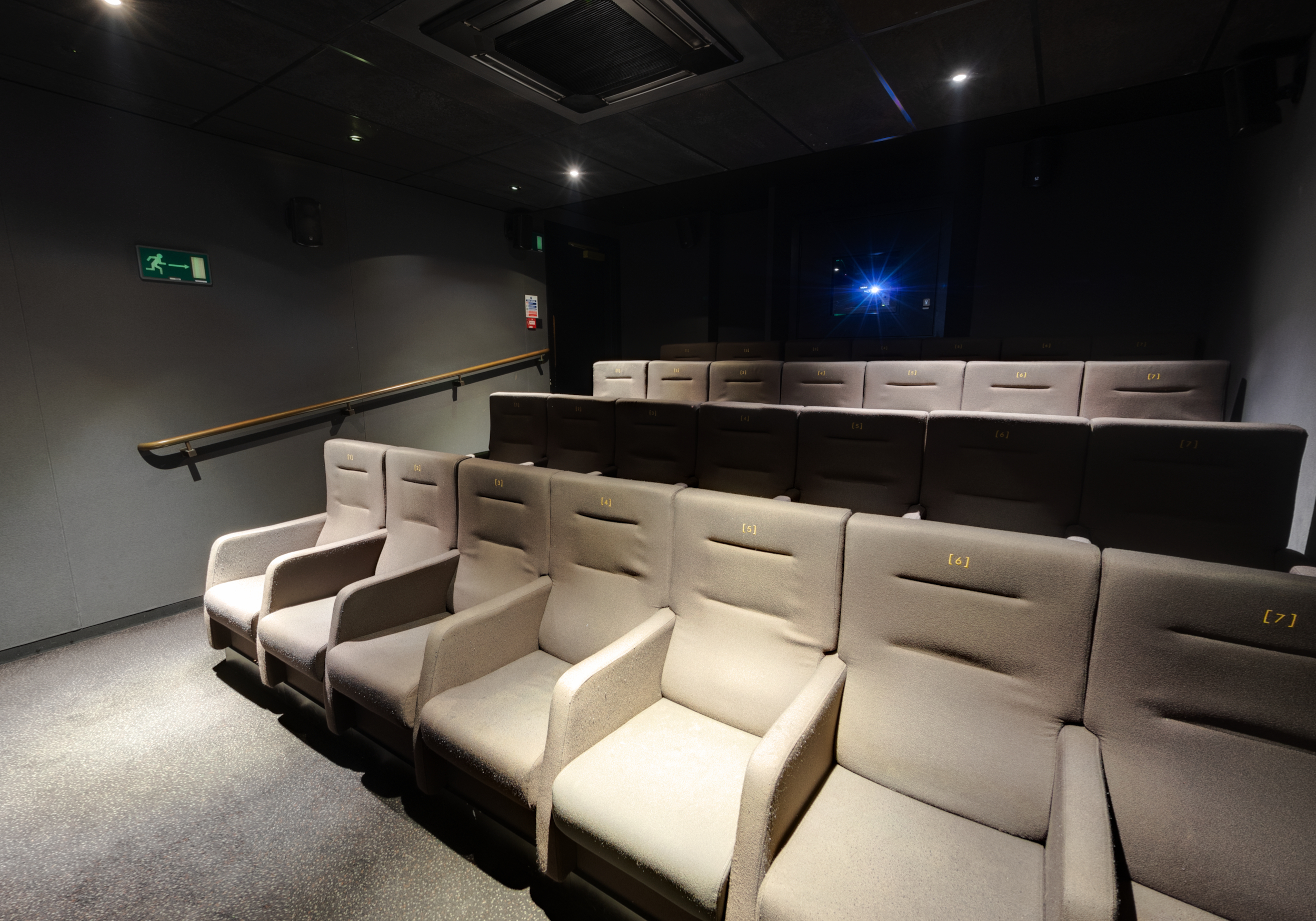 Intimate theater with plush seating for corporate presentations and private screenings.