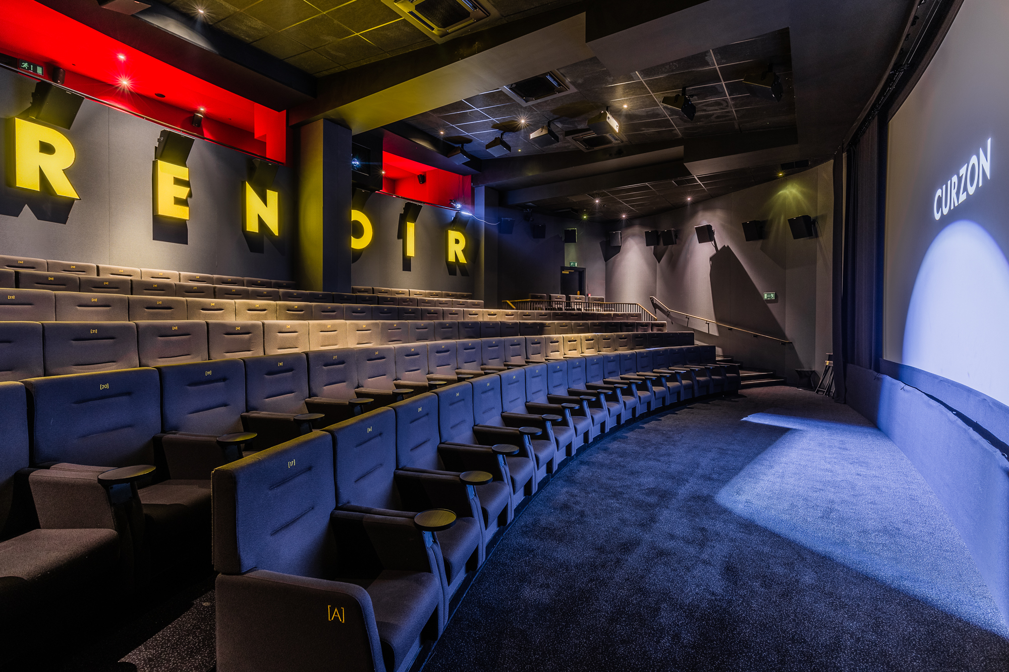 Modern auditorium with tiered seating for corporate events and film screenings.