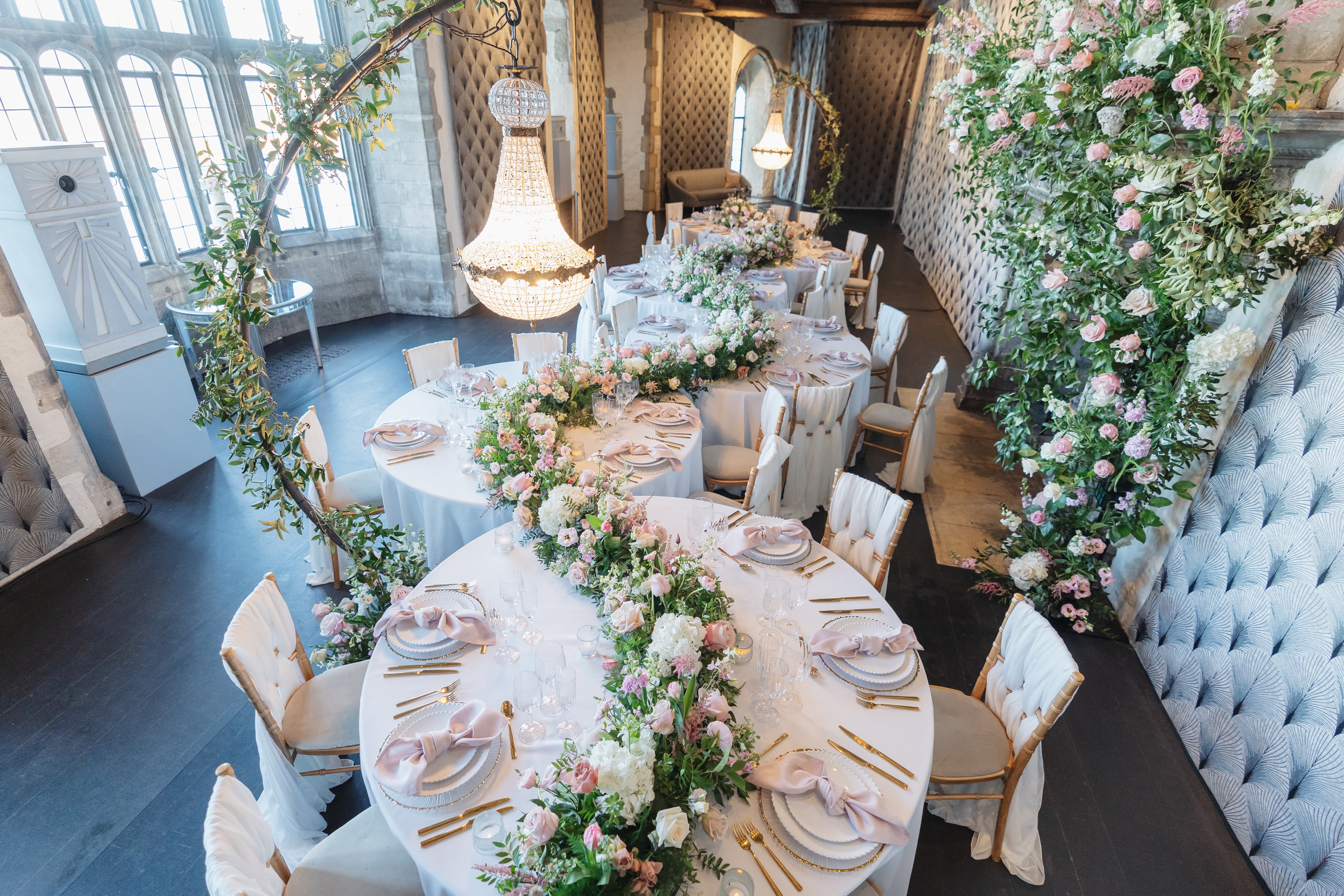 Luxury Leeds Castle wedding reception with serpentine floral tables for high-end event seating.