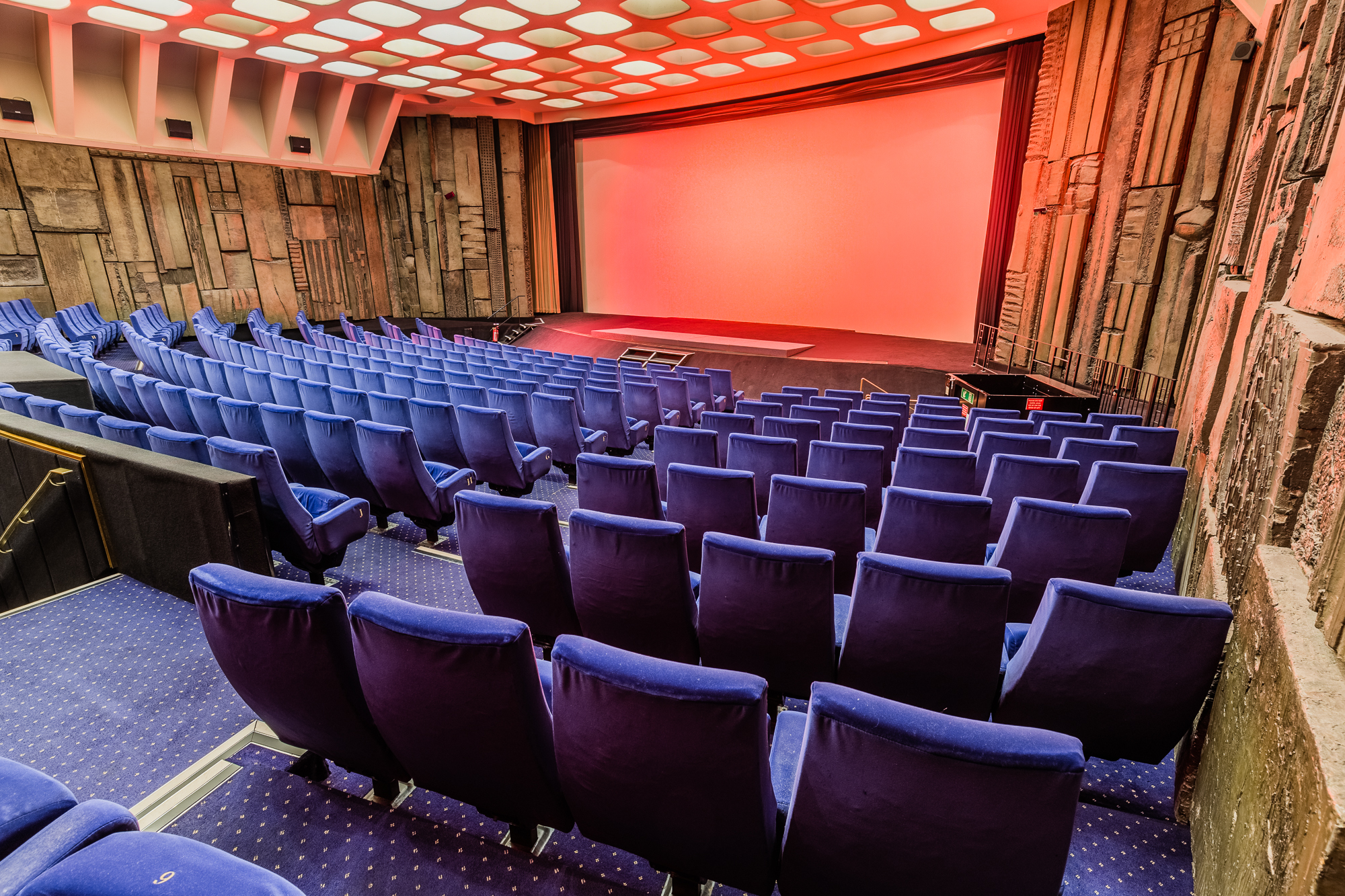 Spacious Curzon Mayfair auditorium with plush blue seating for corporate events and screenings.