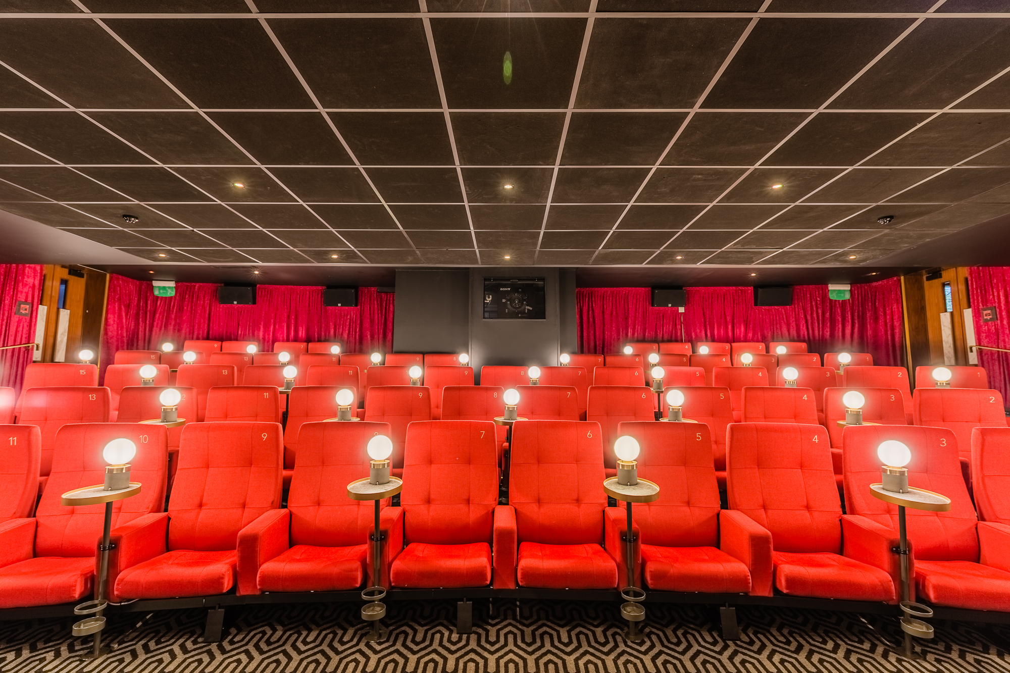 Intimate Curzon Mayfair theater with plush red seating for screenings and events.