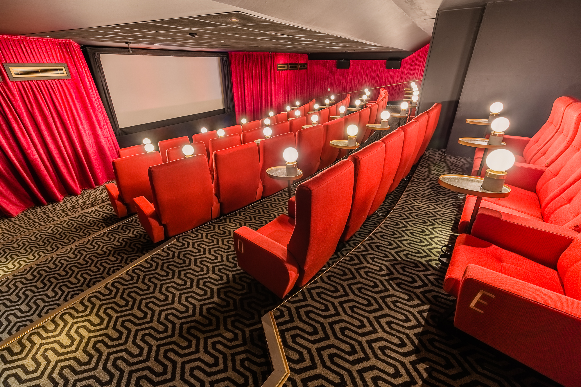 Intimate Curzon Mayfair theater with plush red seating for private screenings and events.