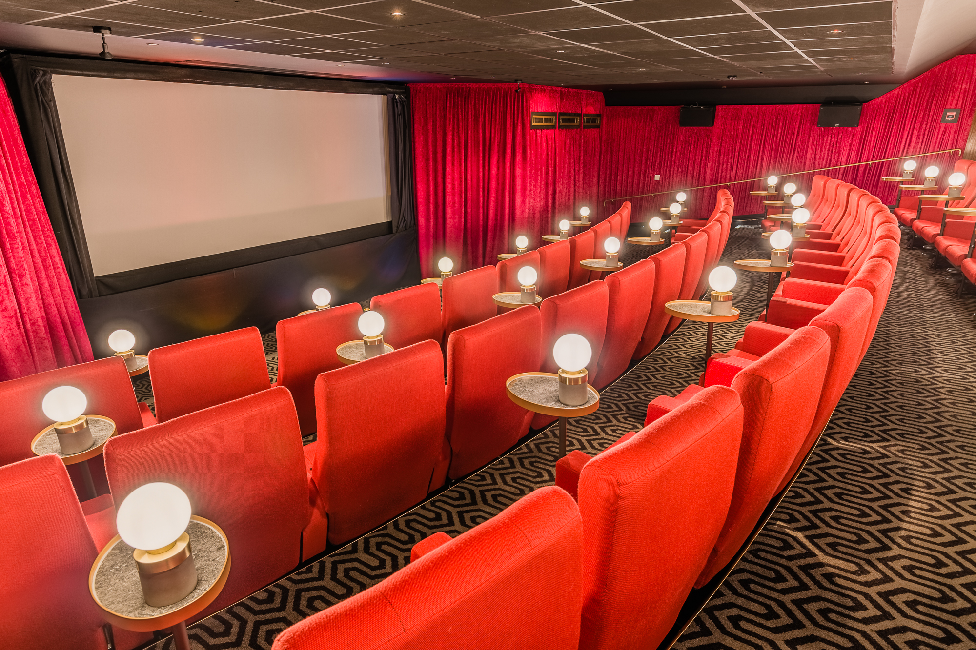 Intimate Curzon Mayfair cinema with plush red seating for private screenings and events.