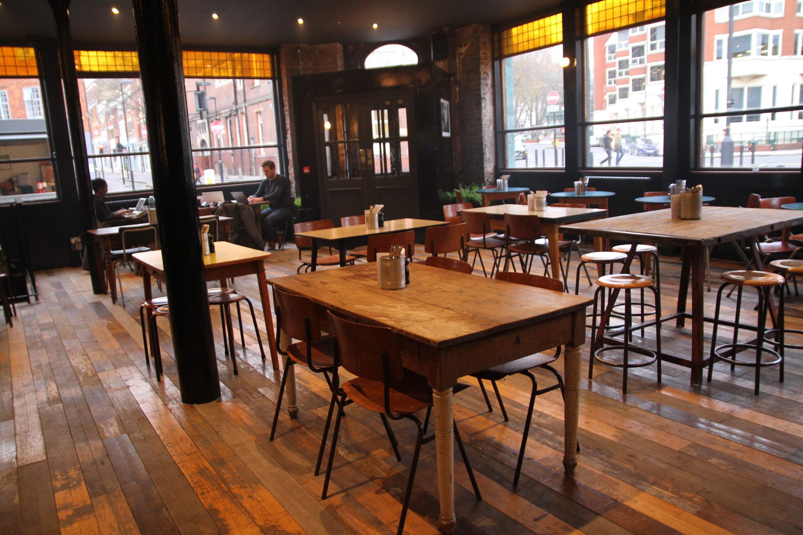 Versatile event space with wooden seating, perfect for meetings and networking.