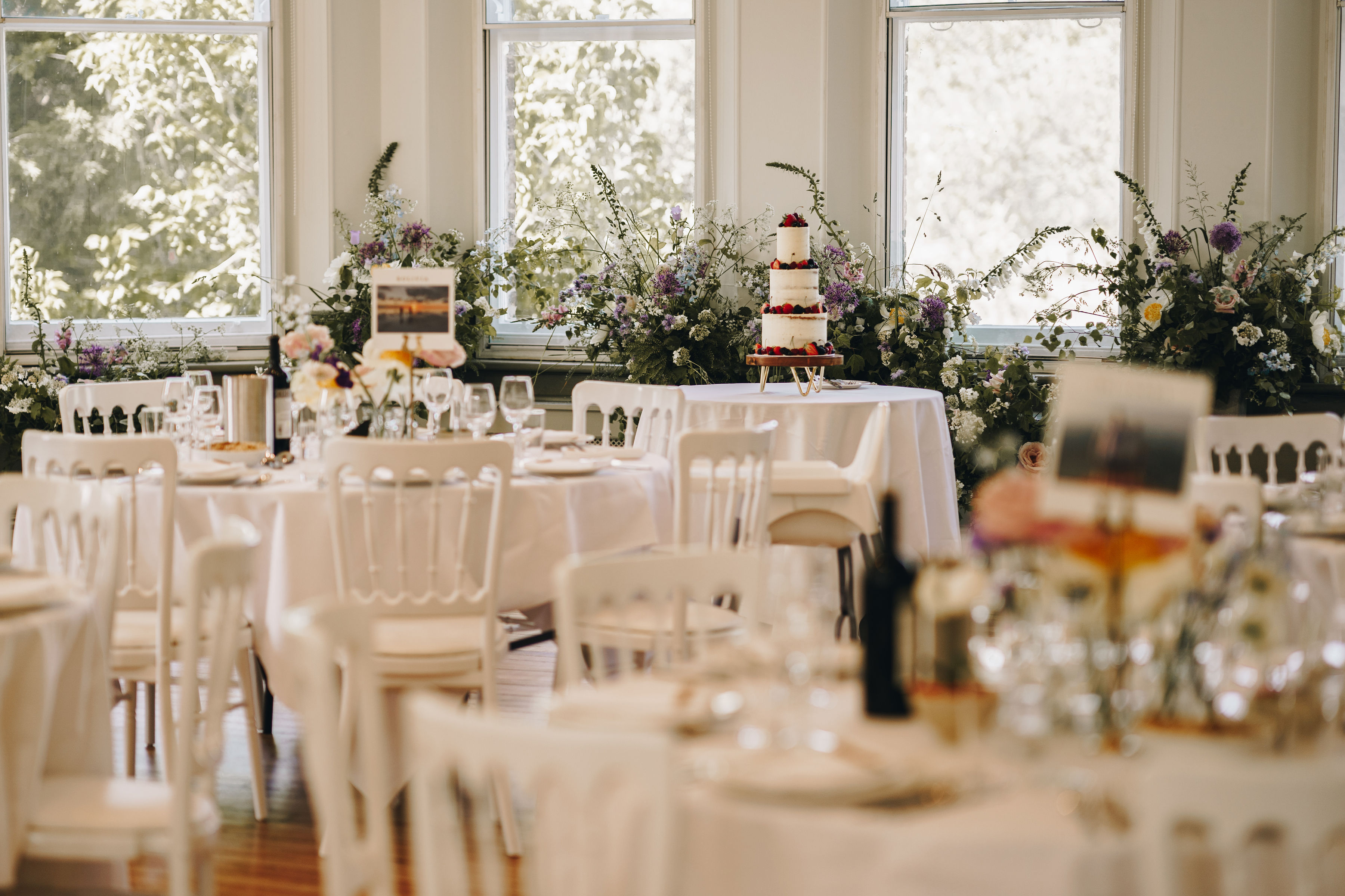 Elegant event space in Winchester House with floral centerpieces, perfect for weddings.