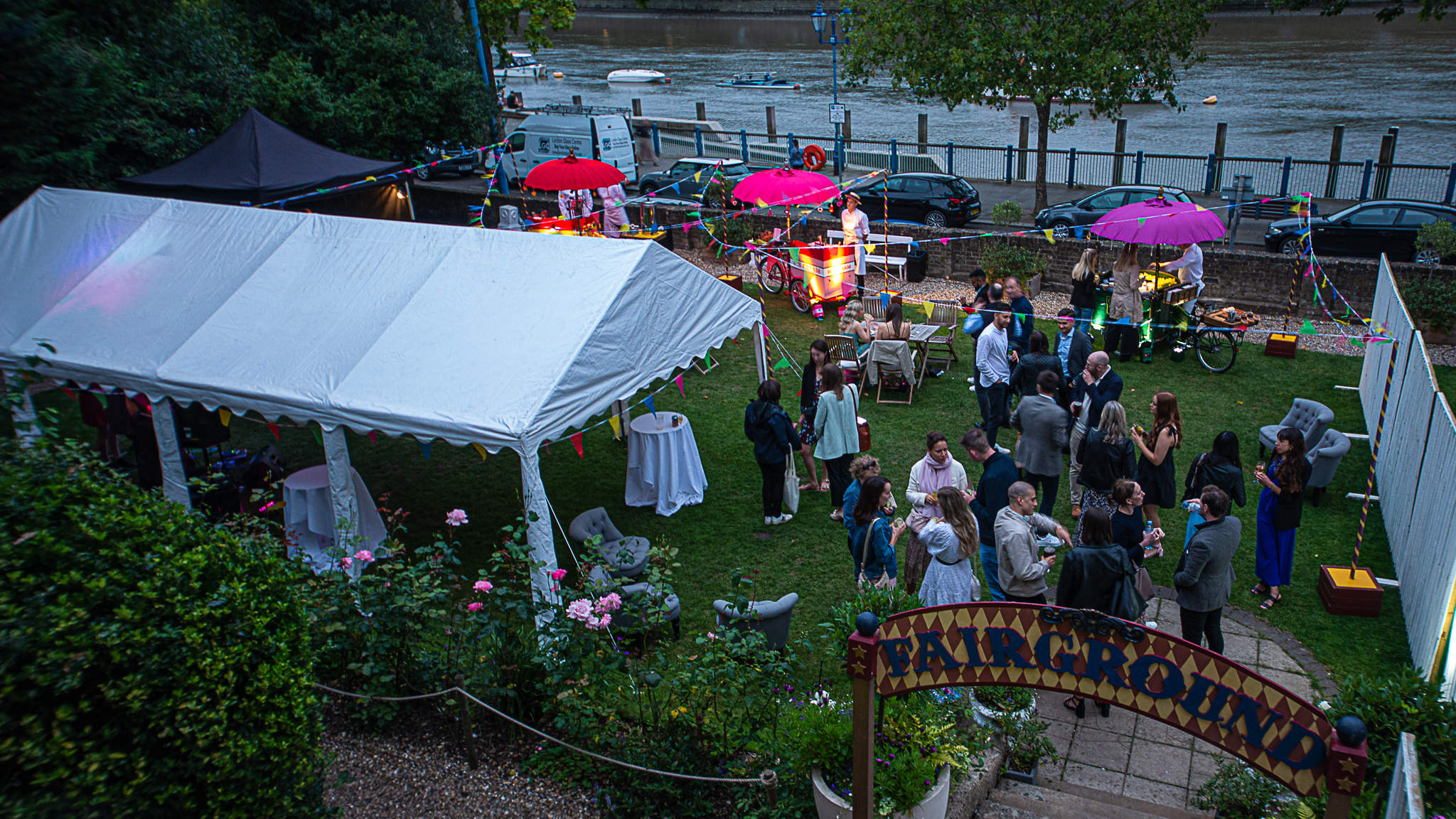 Outdoor event space at Winchester House with a large white tent and colorful umbrellas.