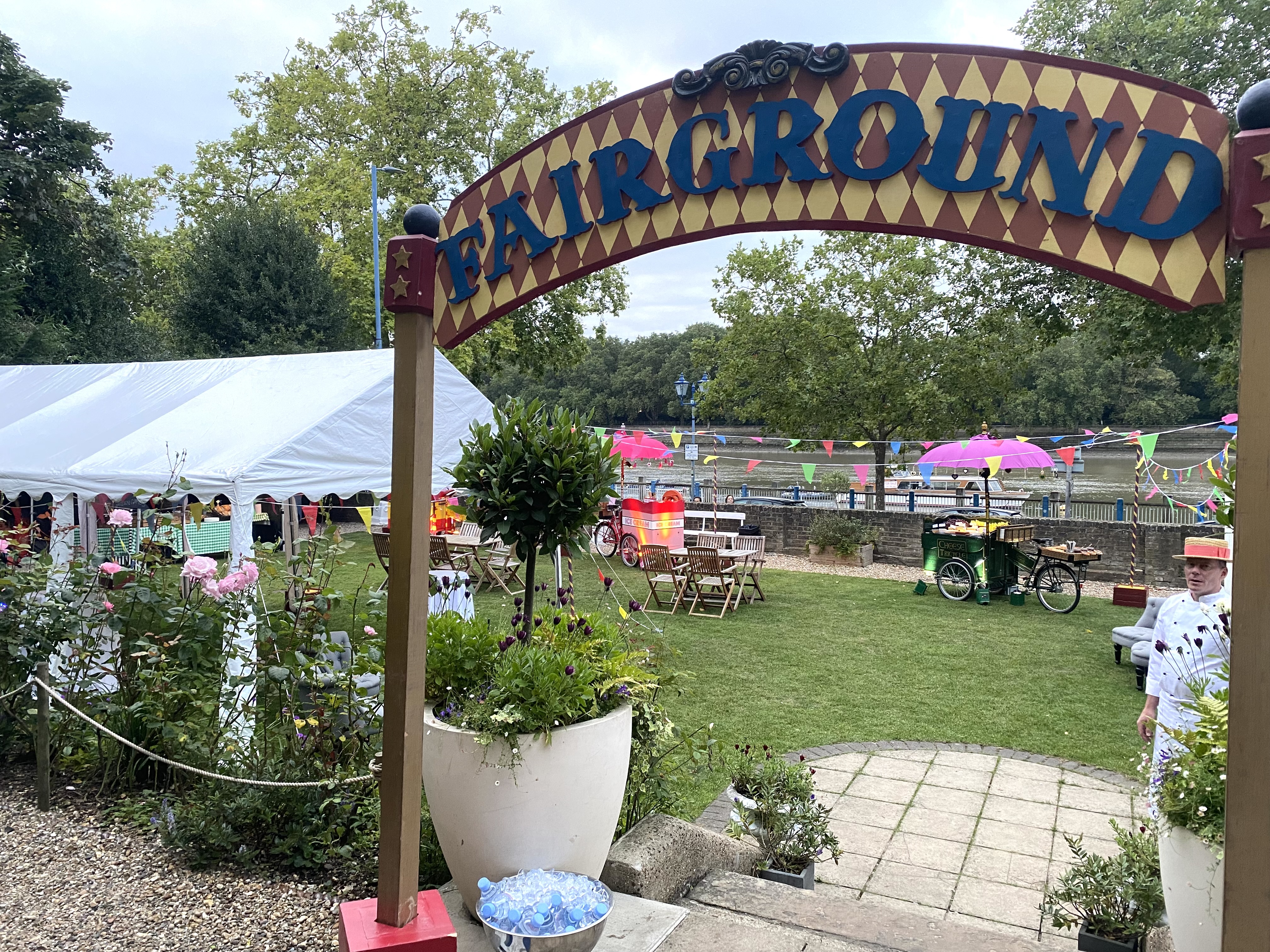 Vibrant outdoor event space at Winchester House with whimsical fairground entrance.
