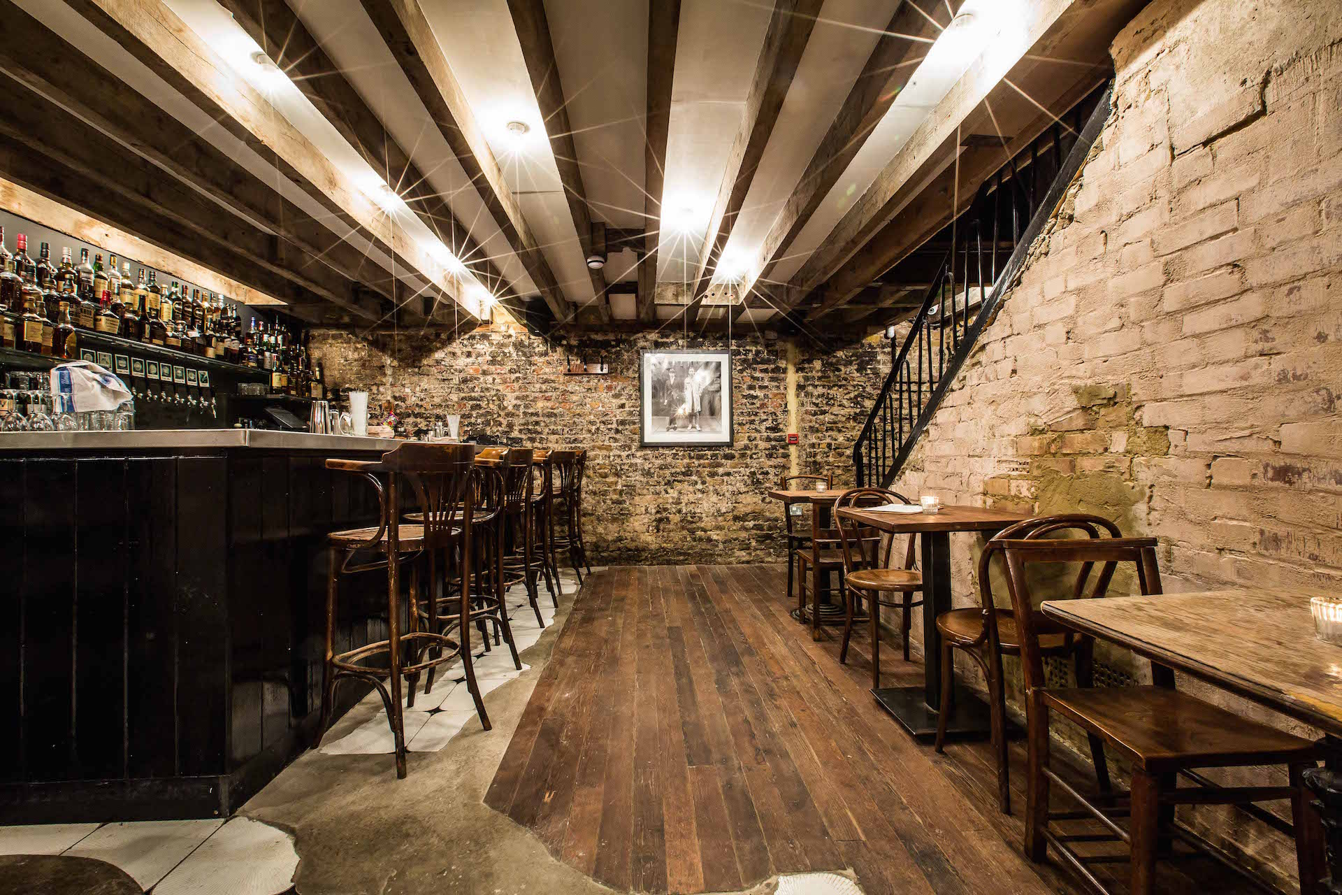 Cozy rustic basement venue with exposed brick for intimate gatherings and private events.