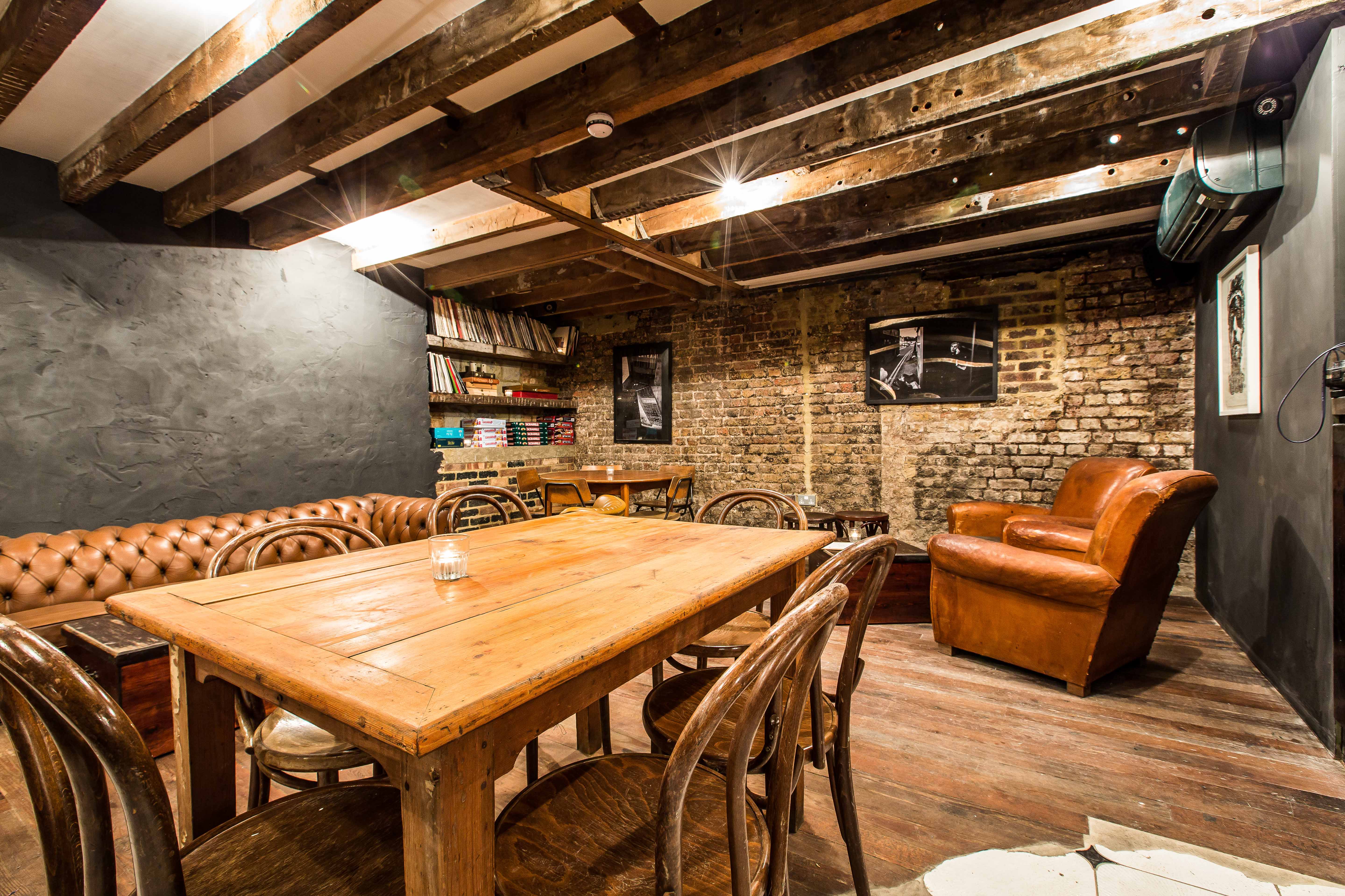 Cozy rustic basement meeting space with warm wood tones for intimate gatherings.