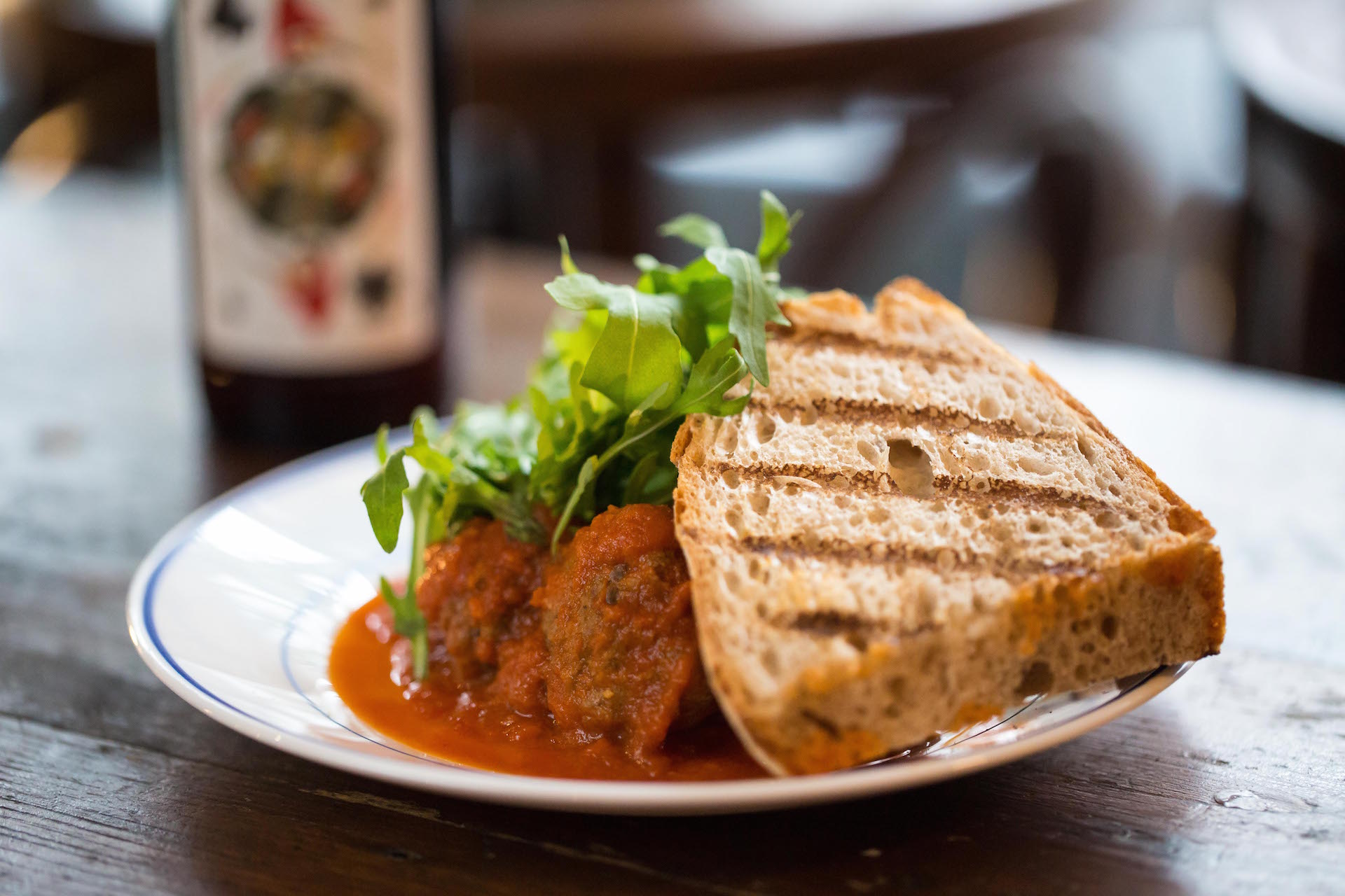 Meatballs in tomato sauce with arugula, ideal for networking lunches and events.