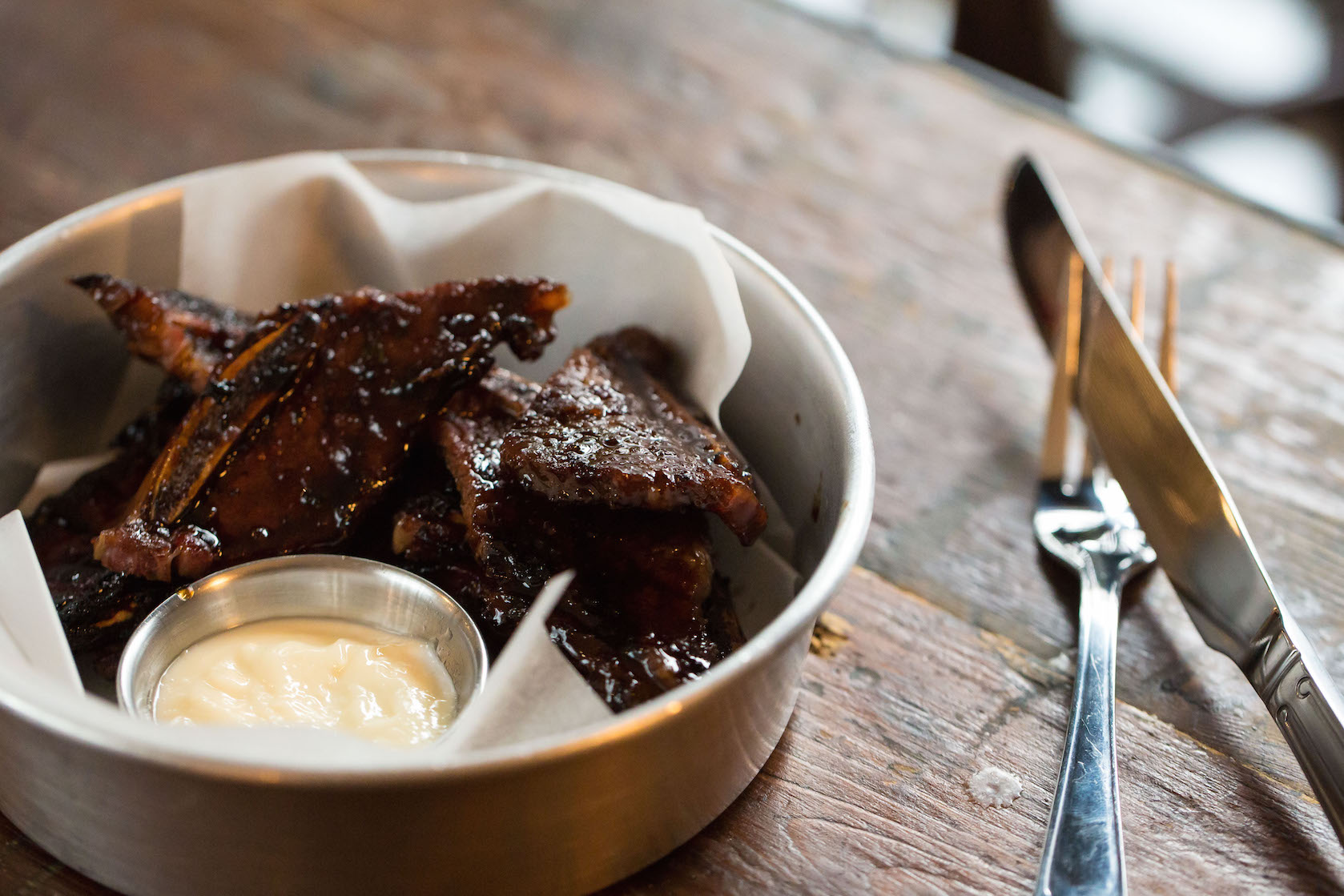 Crispy savory ribs in rustic bowl, ideal for catering at events and gatherings.