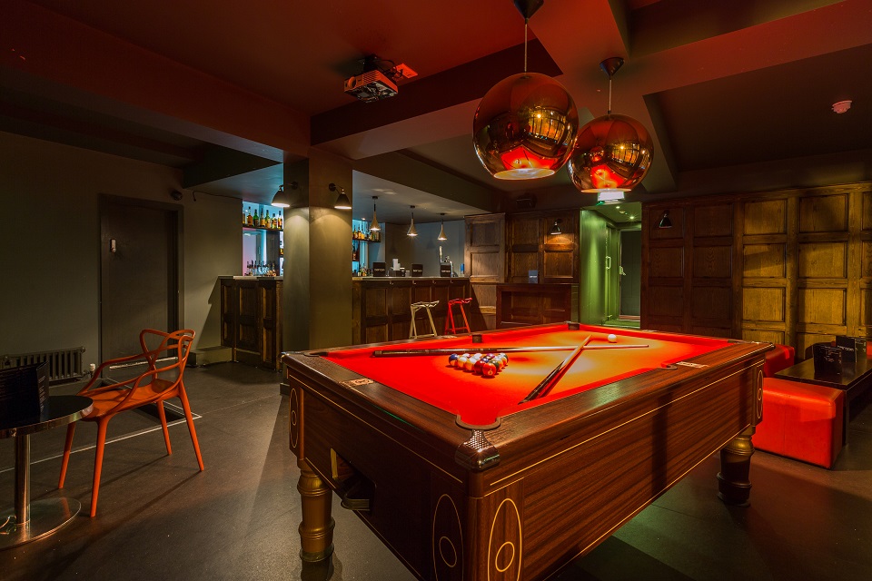 Stylish lounge with vibrant pool table for networking events at Brickhouse Social.