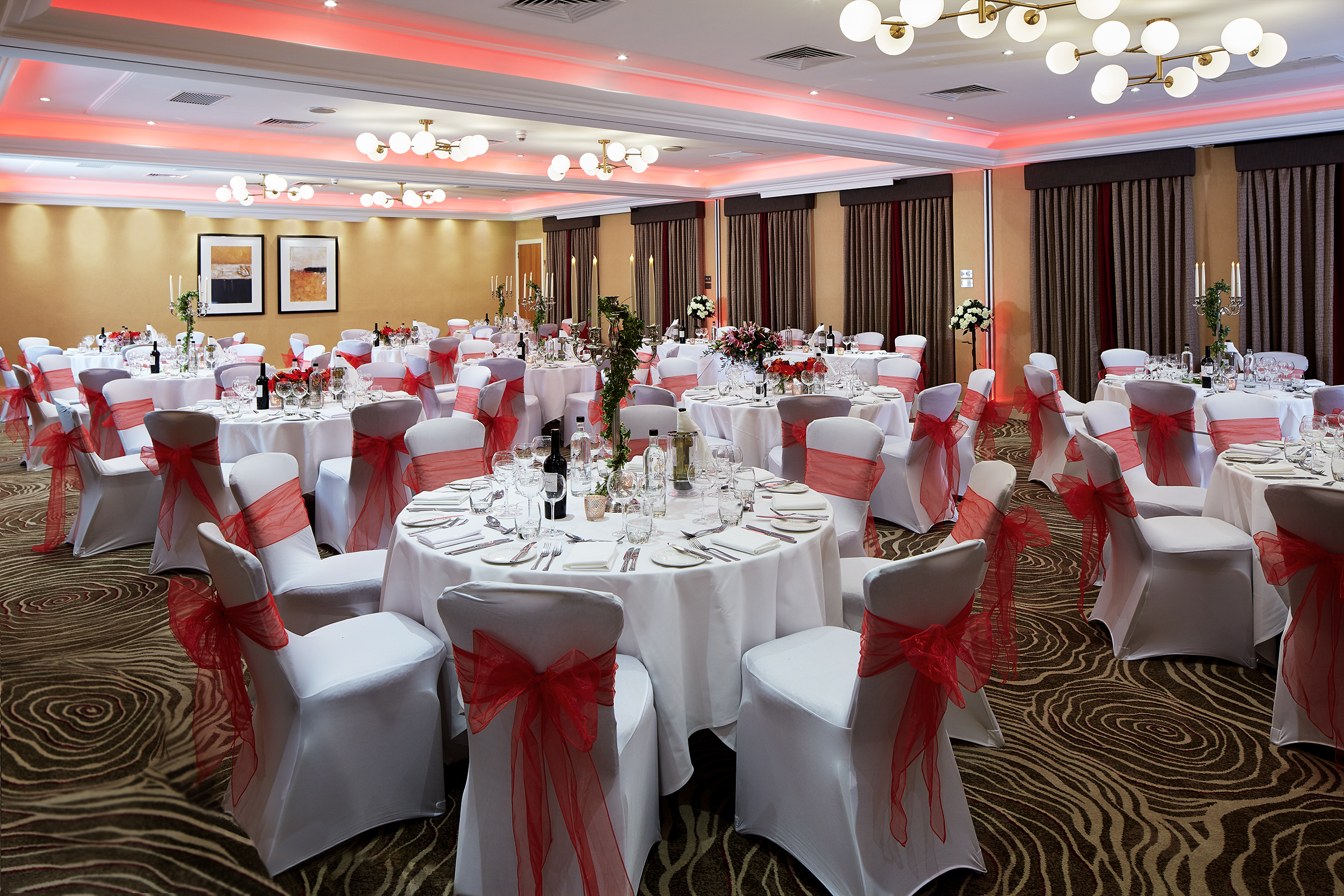 Elegant Kings Suite banquet hall with round tables, perfect for weddings and corporate events.