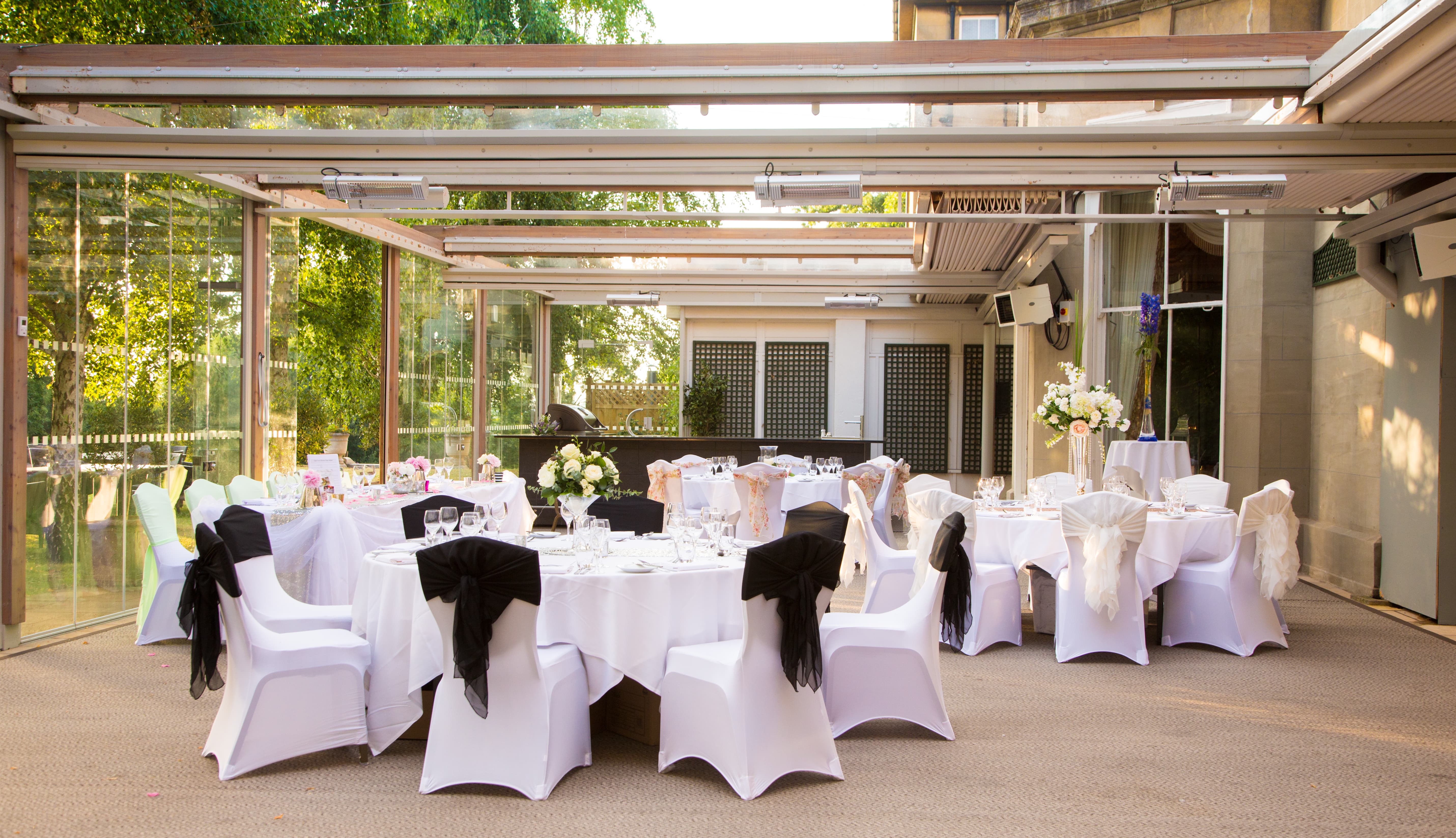 Elegant event space at Oatlands Park Hotel with white tables, ideal for weddings.