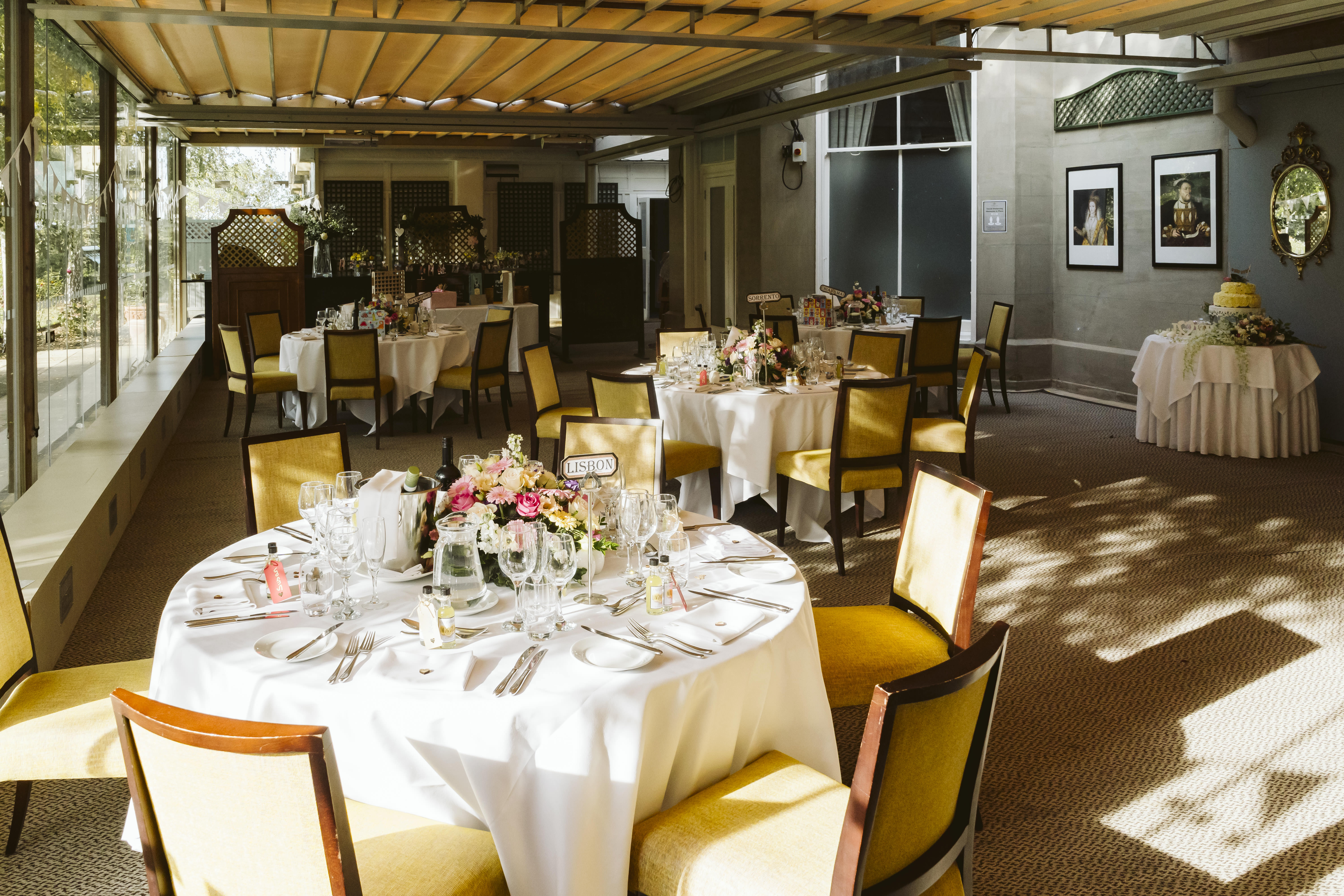 Elegant event space at Oatlands Park Hotel with floral centerpieces and natural light.