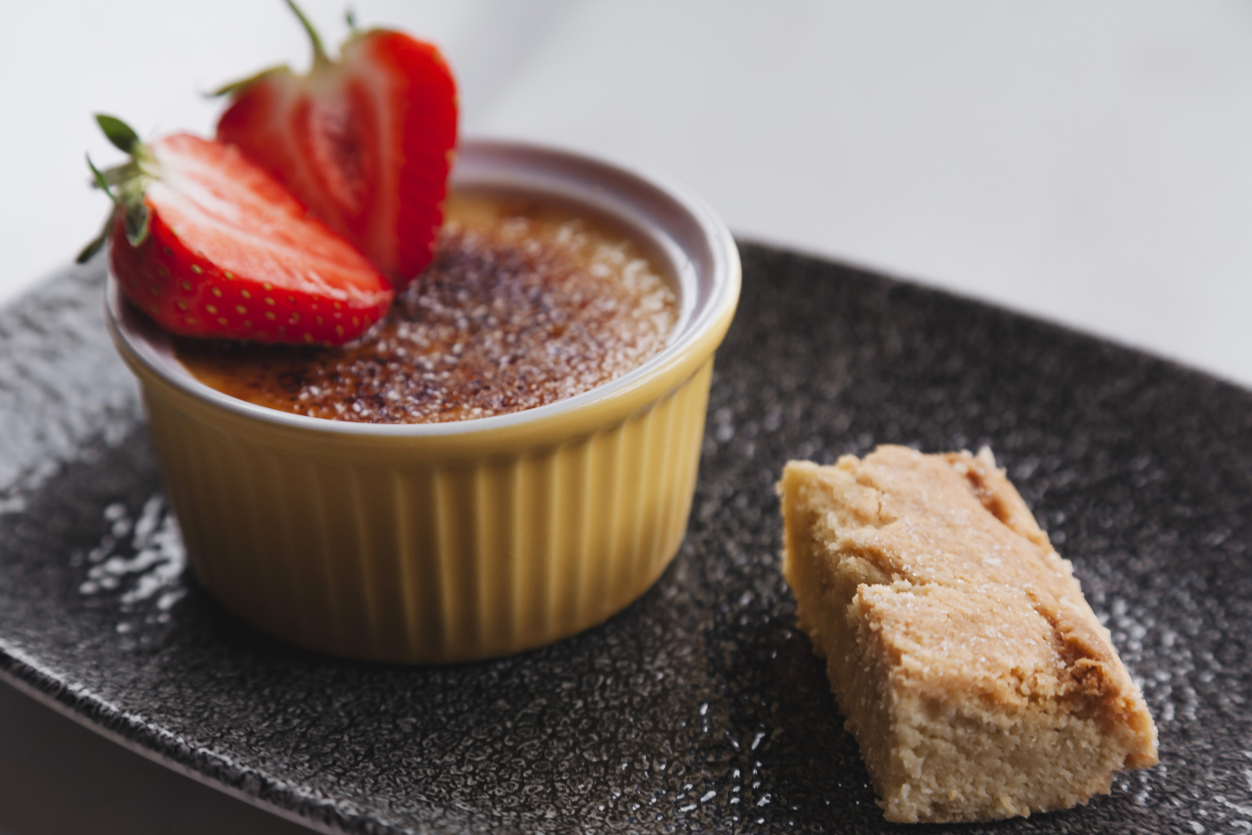 Elegant crème brûlée dessert with strawberries at Oatlands Park Hotel event catering.