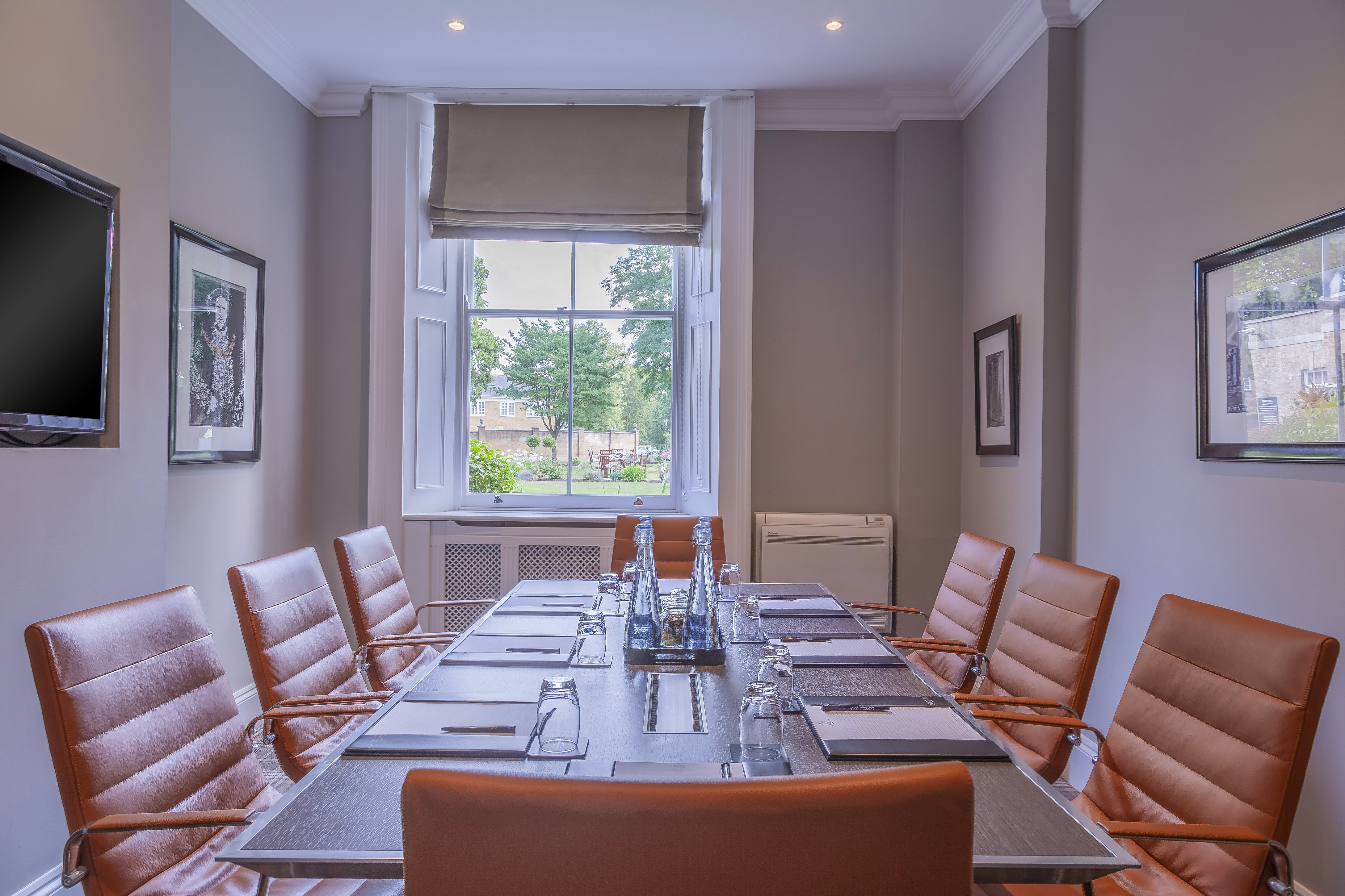 Howard Room at Oatlands Park Hotel, featuring a sleek conference table for meetings.