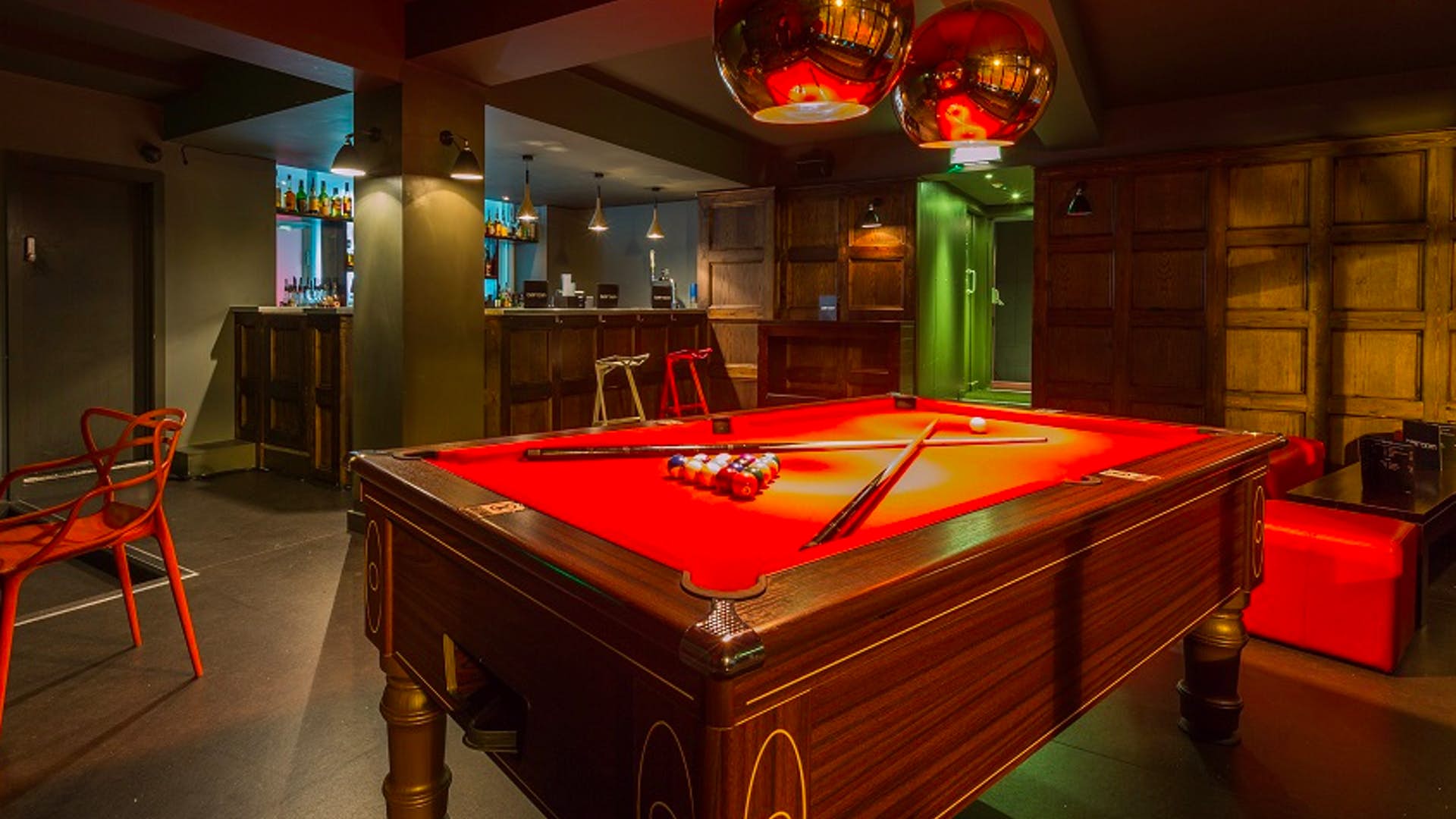 Stylish lounge with red pool table for team-building and networking events at Brickhouse Social.
