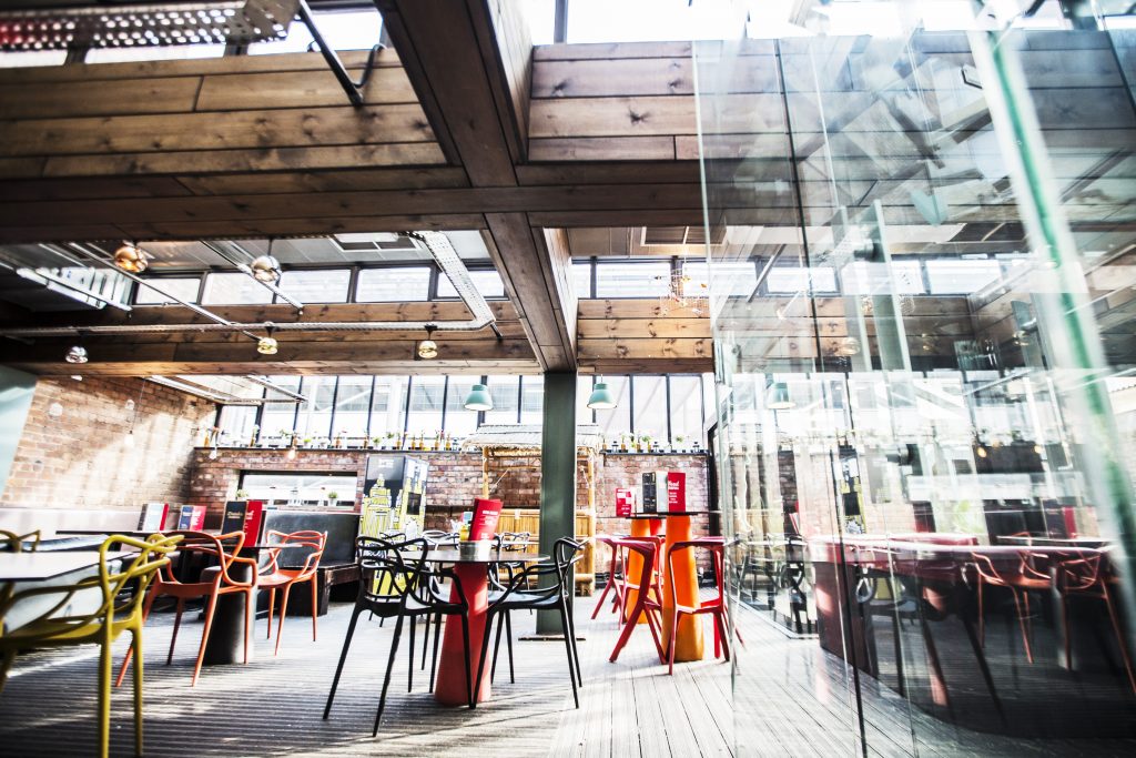 Modern event space with natural light and colorful seating at Brickhouse Social.
